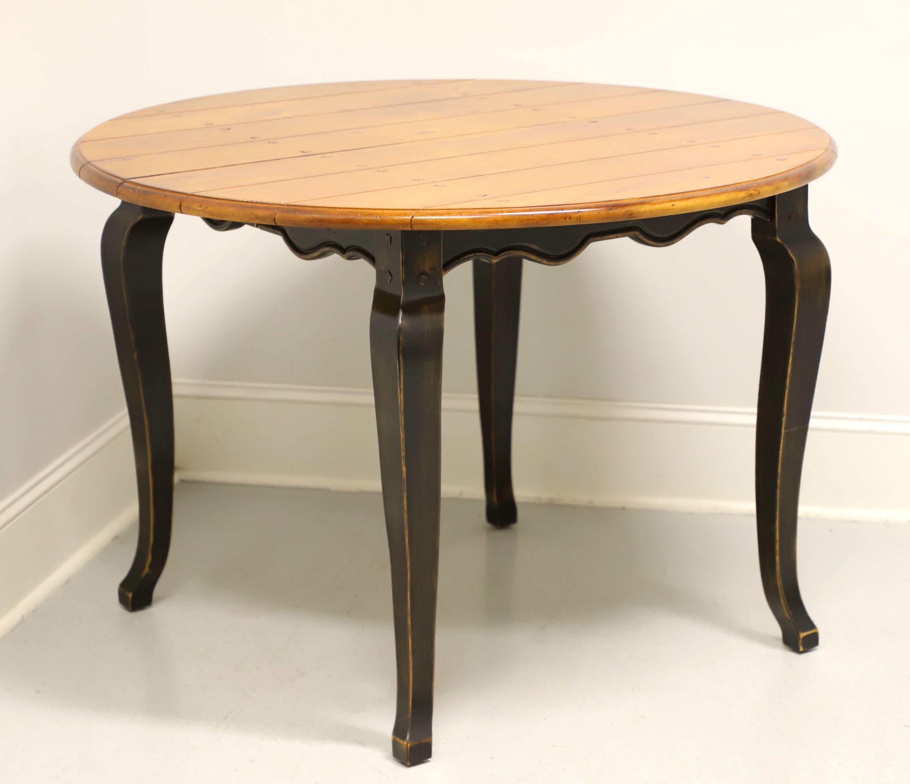 A dining table in the French Country style by Lorts Furniture. Pine with natural plank style top, black painted scalloped skirt and cabriole legs. Expandable on wood expansion sliders and includes one extension leaf. Made in Goodyear, Arizona, USA,