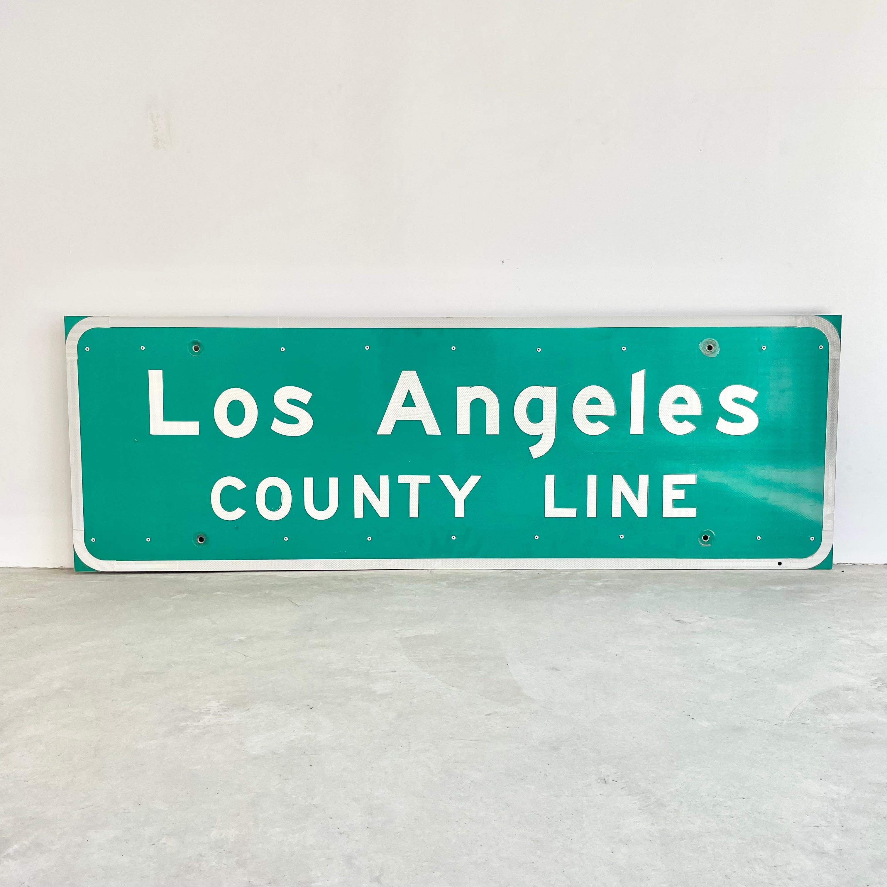 Super cool Los Angeles freeway sign. Made in the late 1990s. This sign welcomed you as you entered the county of Los Angeles. Reflective letters and border as well as a protective plastic sheet over the face. Stamped 