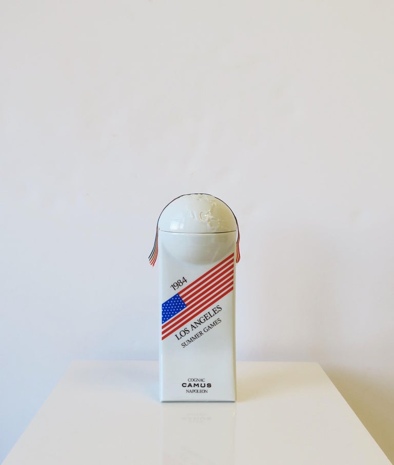 A beautiful and cool numbered limited-edition Los Angeles Summer Games World Globe French white porcelain cognac bottle, 1984. This chic piece made exclusively for the USA Summer Olympic games, Los Angeles, California, 1984. Made in France. Piece