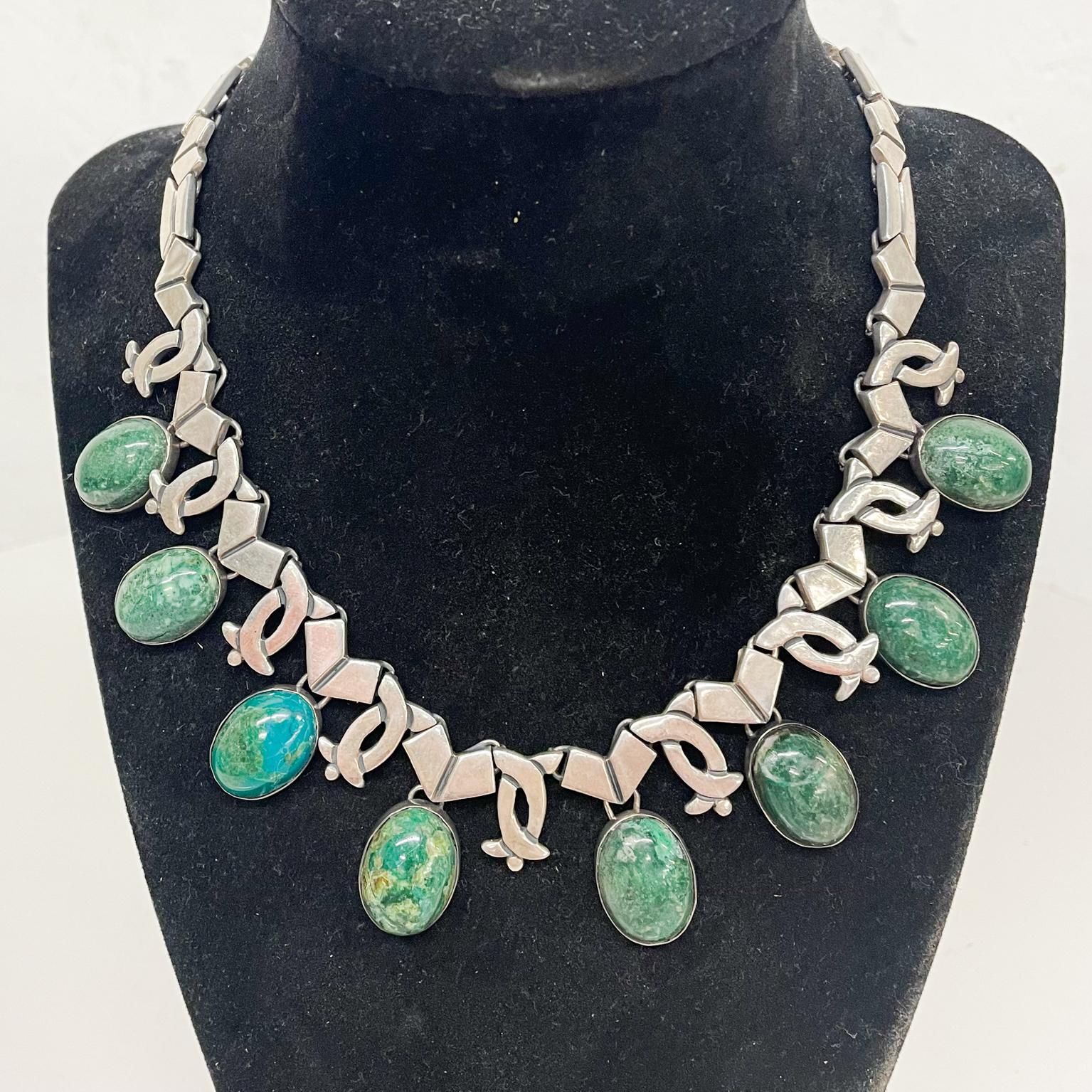 Necklace
Modernist Talleres Los Ballesteros choker collar necklace in green stone and sterling silver 1960s Mexico Taxco
Inspired by William Spratling and Mayan design
Measures: 15 L x 1.25 H inches and weight 81.8 grams
Refer to images