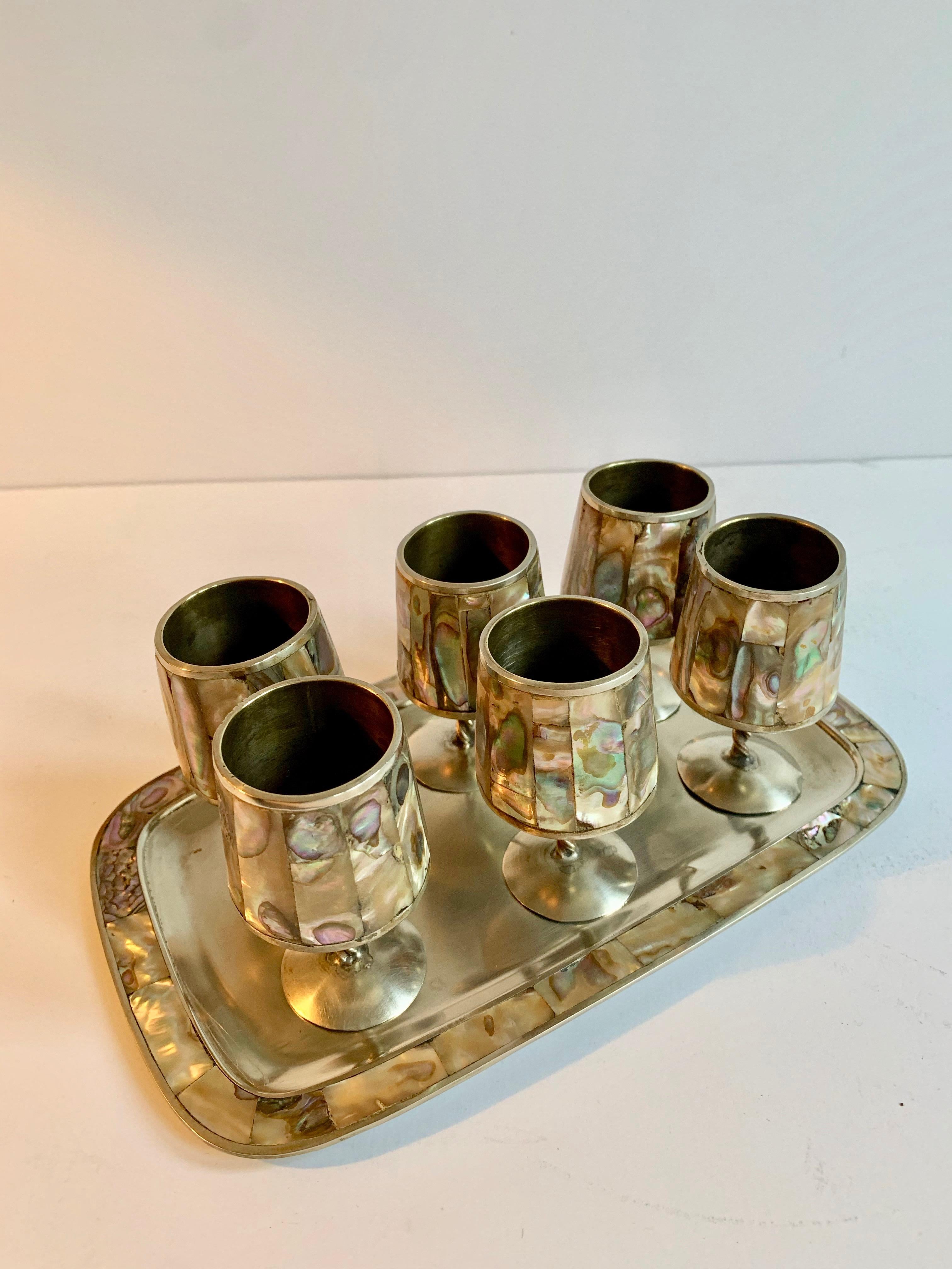 A handsome 7 piece set of Mexican Alpaca Silver Mexico. 6 Cordials and a tray... All in good condition with no missing pieces.

Leave the traditional and use the set for cocktails, mocktails or a petite liqueur Dessert... a wonderful gift, holiday