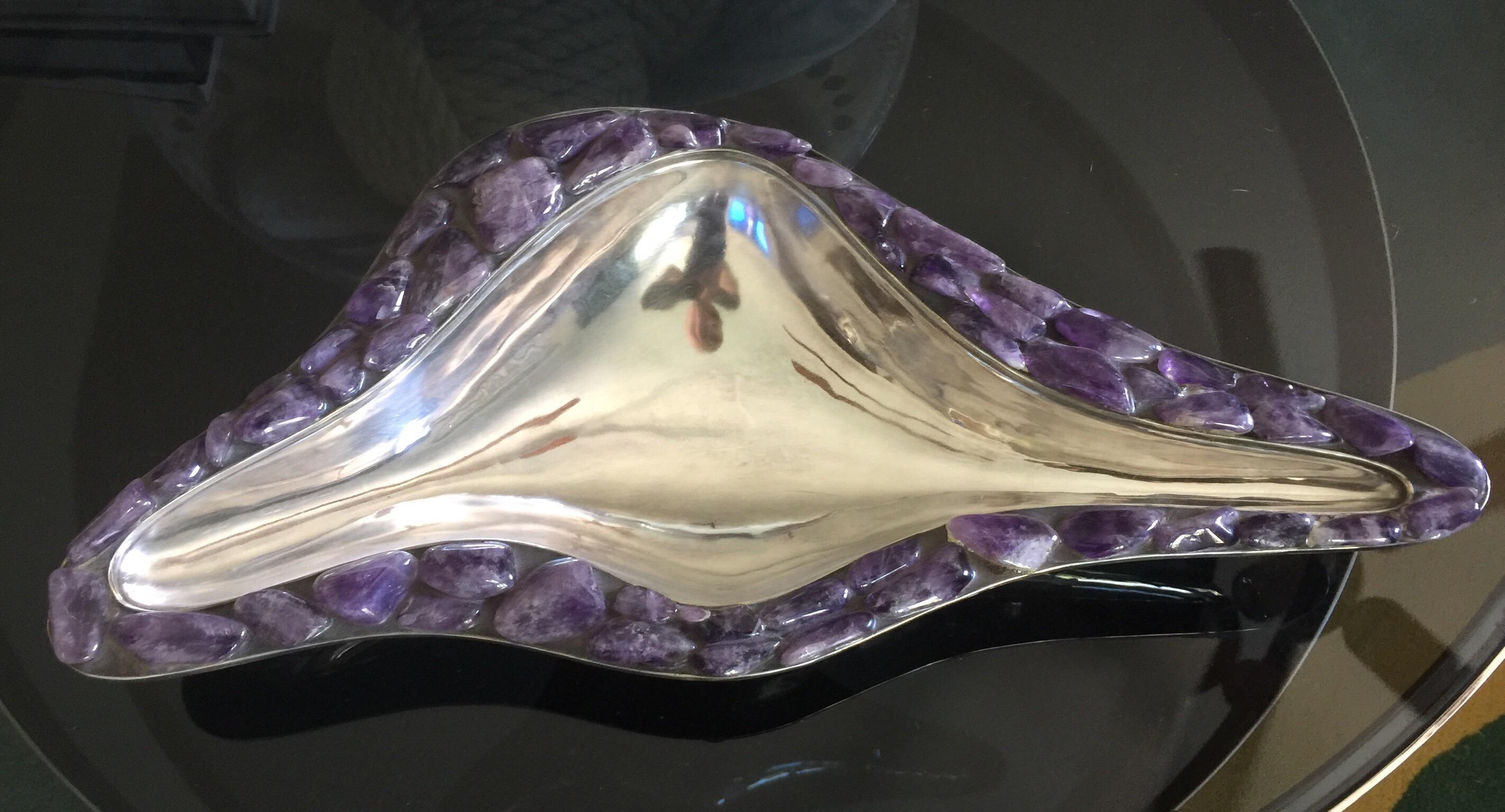 Marked to underside, made in Taxco, Mexico, this hand wrought bowl is covered beautifully with amethyst cabochon semi-precious stones and silver-plate.