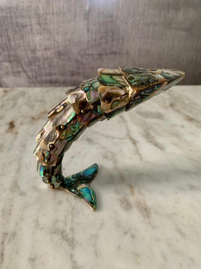 An articulated Abalone Fish Bottle Opener - Los Castillo, Mexico - a wonderful midcentury bottle opener that when bent rests on it's tail standing.. for the sophisticated bar keeper.