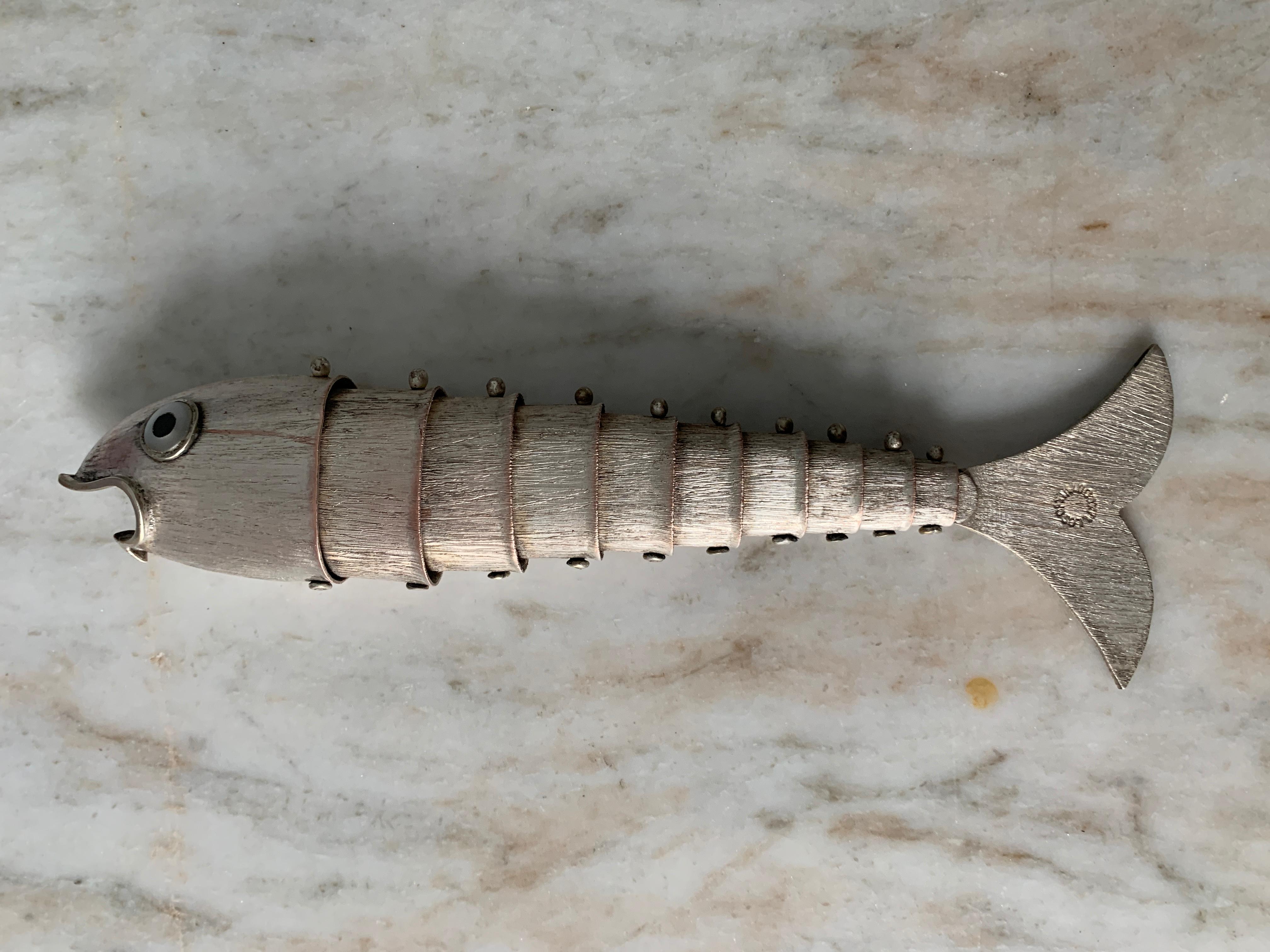 A unique and rare Los Castillo Articulated metal fish bottle opener. The piece is well suited for the serious bar and especially those that have a sophisticated midcentury theme. The fish were designed to stand on edge, which is a novel addition to