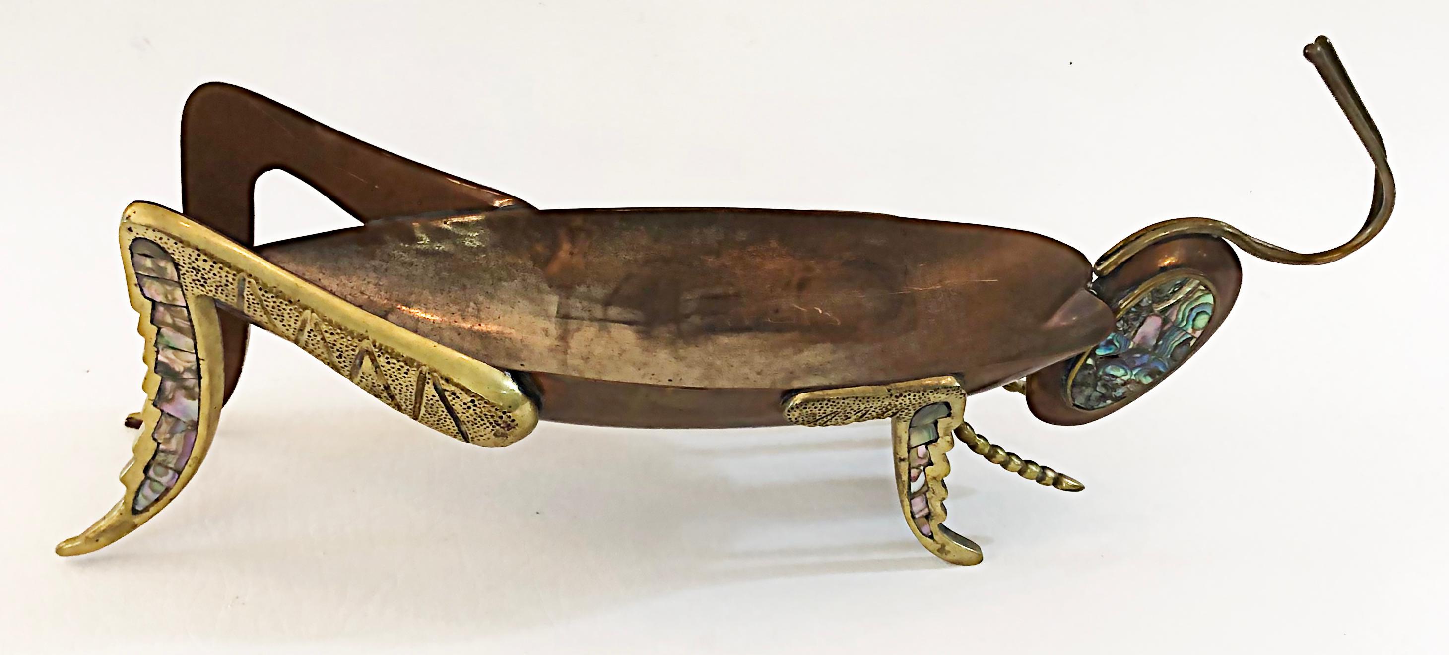 Los Castillo Metales Casados Mexico Abalone Cricket tray, 1950s

Offered for sale is a Los Castillo Metales Casados married metals cricket tray in copper and brass with inset abalone shells on the head and both front and back legs. The process to