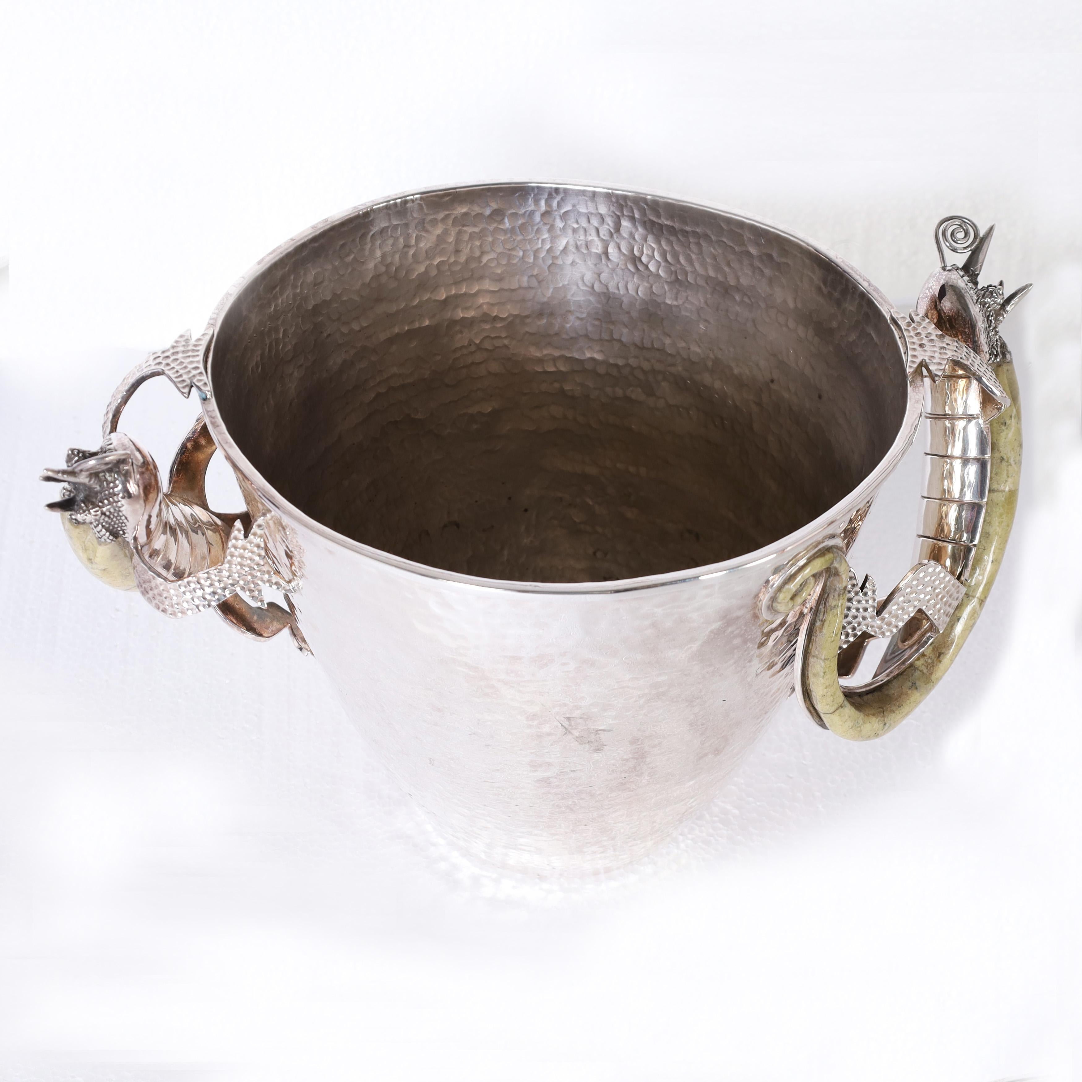 Standout vintage ice bucket handcrafted in hammered copper under silver plate in modern form featuring stone clad lizards as handles. Stamped Los Castillo 1967 on the bottom.
