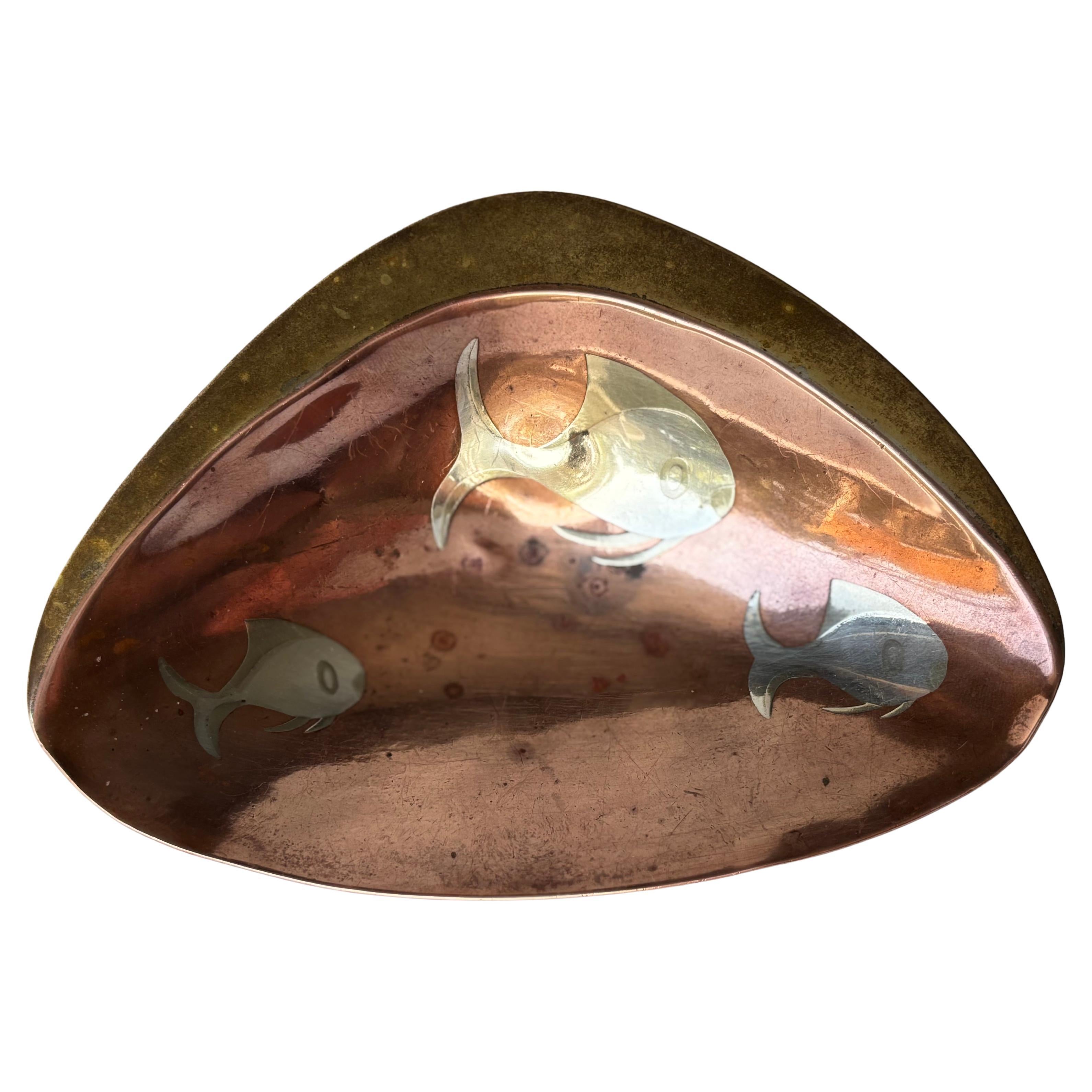 Los Castillo , mix metals footed bowl , copper, brass , silver with fish .