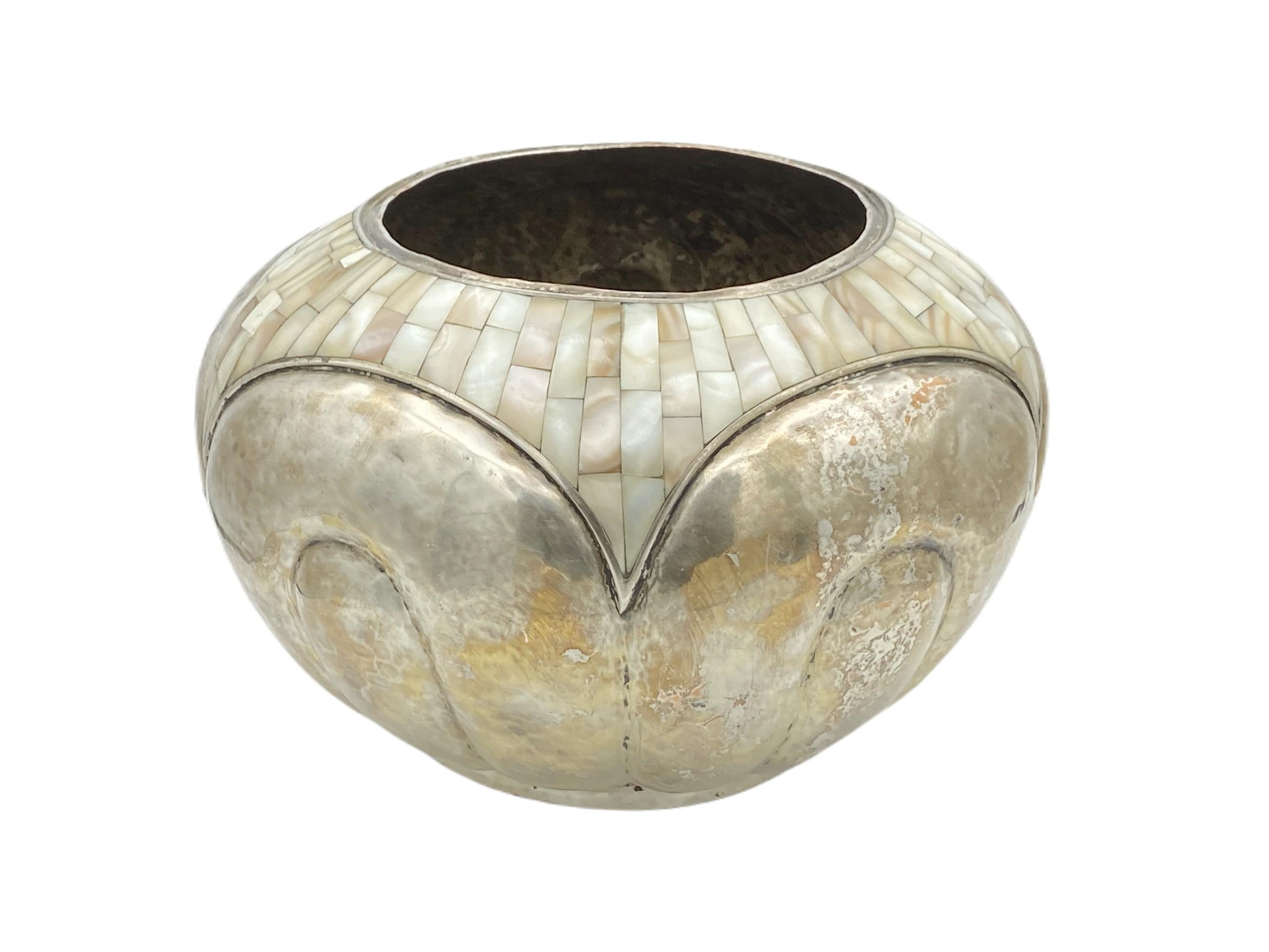 Experience timeless beauty with this exquisite Los Castillo handwrought silver plate hammered vase, featuring an intricate inset Mother of Pearl mosaic. Handwrought, this striking piece will captivate admirers with its eye-catching design and