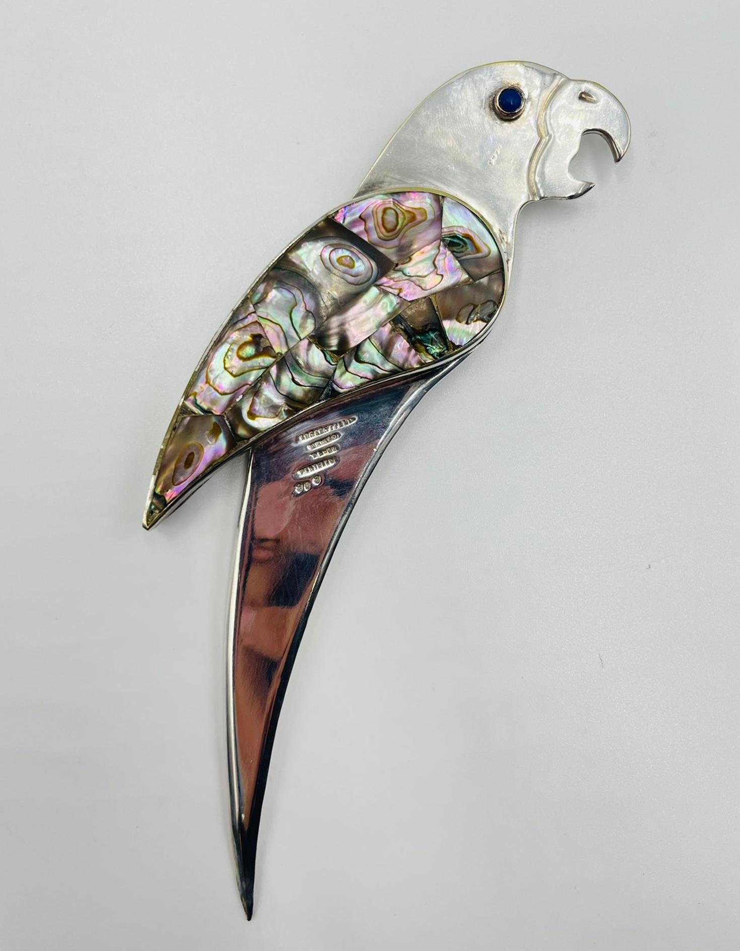 Striking parrot-shaped bottle opener designed and handcrafted in Taxco, Guerrero, Mexico by the legendary Los Castillo workshop, pioneers of 20th-century Mexican modern design. The piece is crafted in solid brass, silver-plated, and intricately