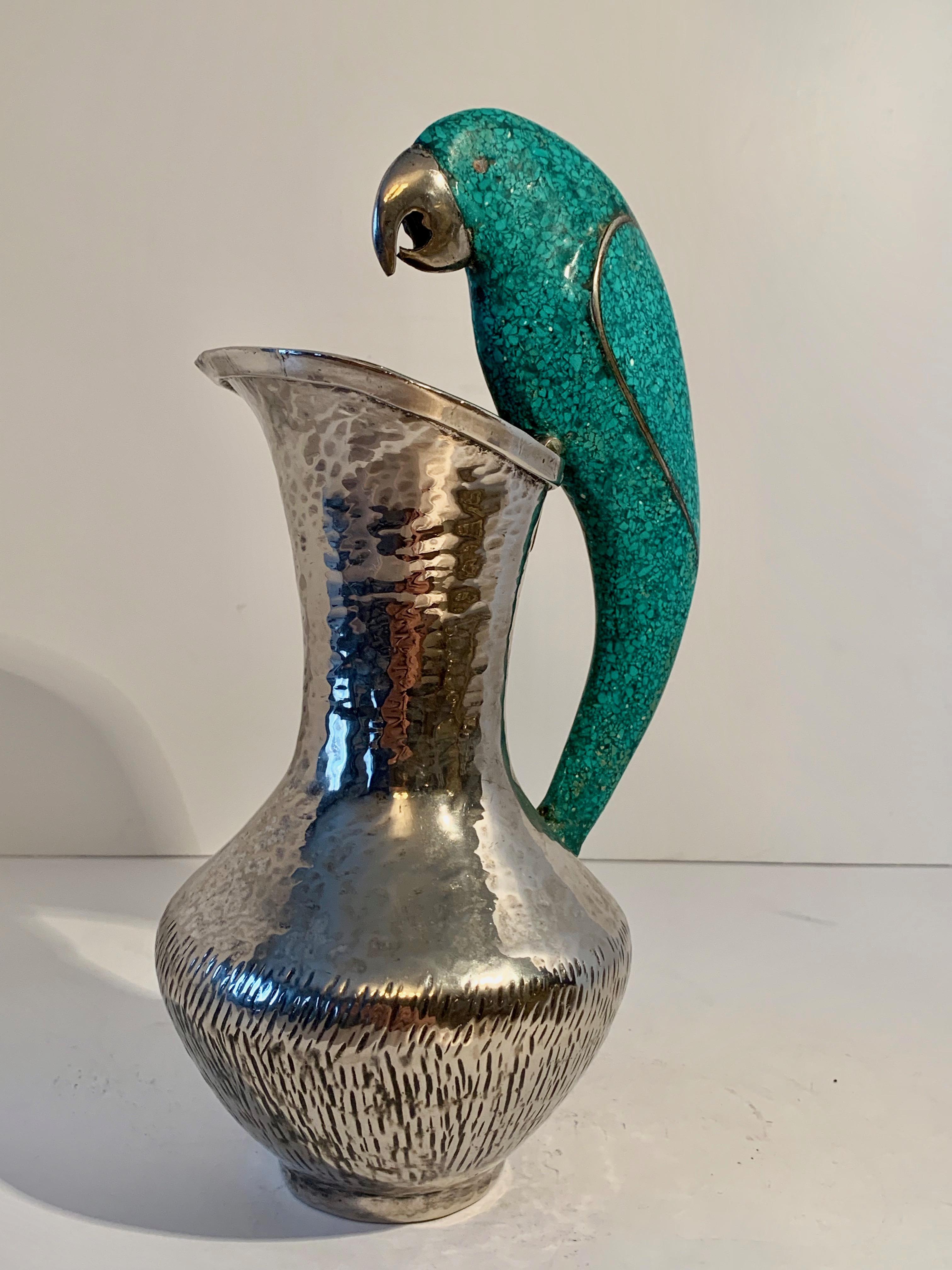 Los Castillo silver plate pitcher with parrot handle in turquoise. Useful as a pitcher, however, equally stunning as a decorative piece. For the Sophisticated bar, the parrot lover or to water your plants! From Mexico by Taxco of Mexico.