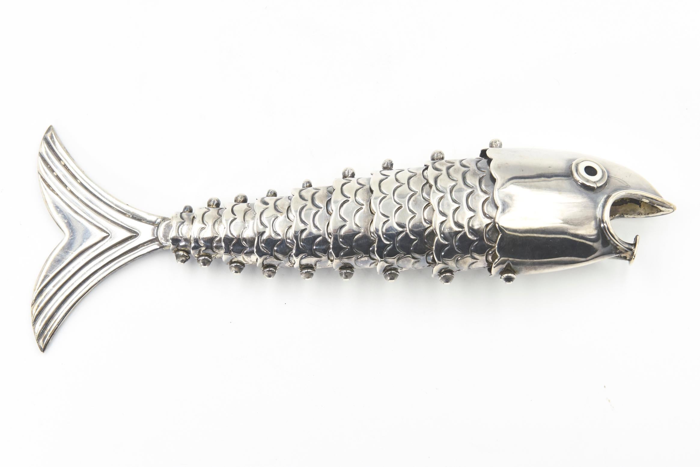 Los Castillo Mexican silver plated articulated fish bottle opener. This is a gorgeous articulated bottle opener is made to look like a fish. This piece features so much detail, as evidenced by the scales and the 10 articulated pieces that allow it