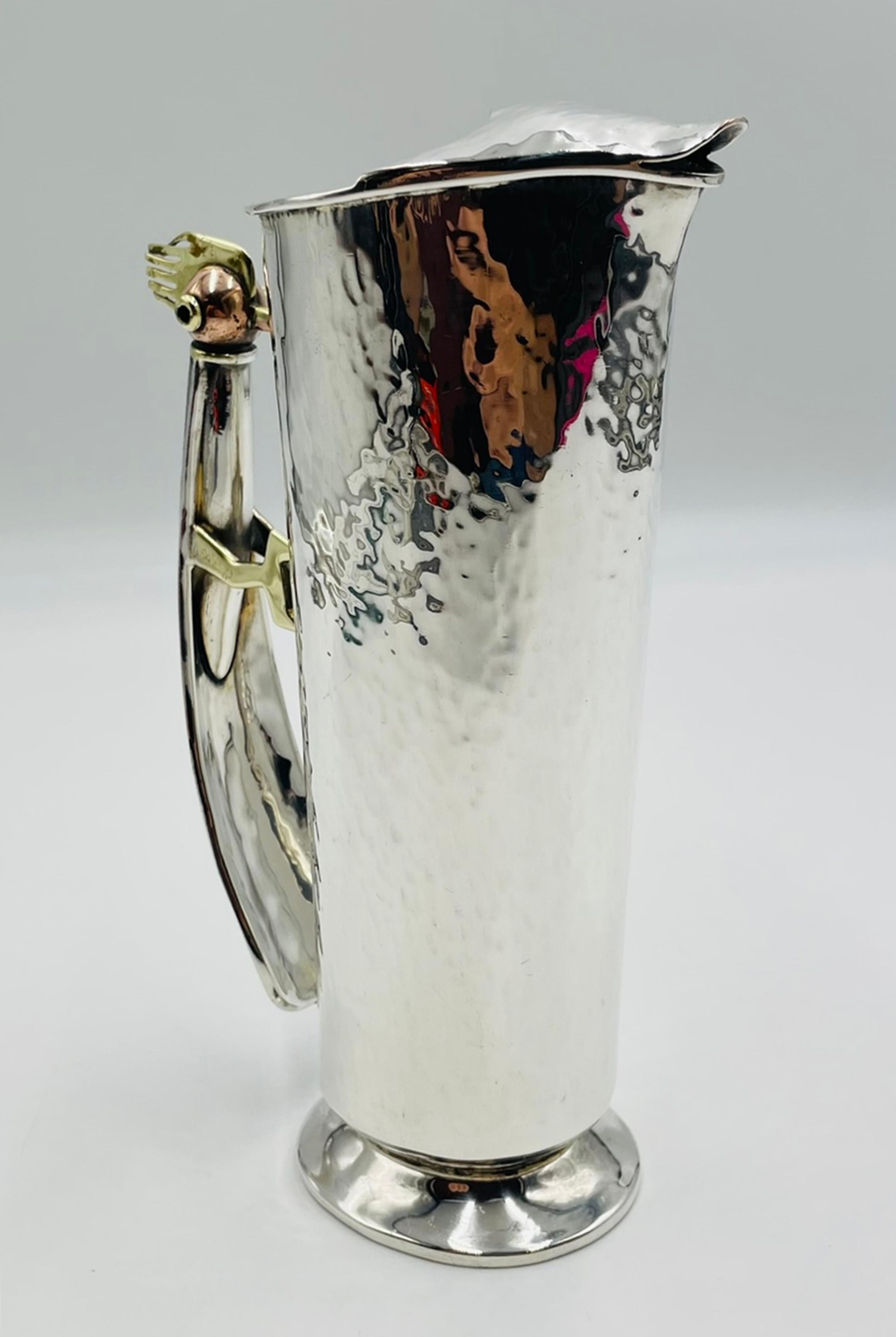 A whimsical and highly collectible silver-plated water pitcher designed and manufactured in Taxco, Mexico by the celebrated workshop Los Castillo. This sculptural vessel showcases the firm’s signature blend of mixed metals, innovative forms, and