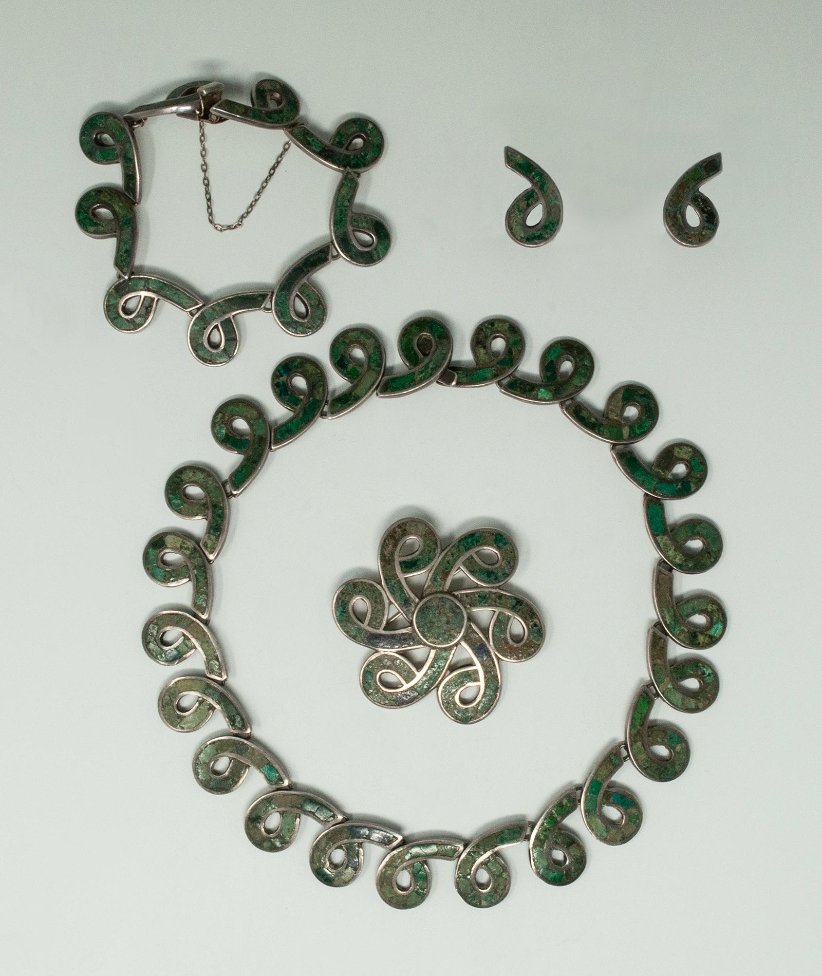 Los Castillo Sterling Silver with Inlaid Stone, Taxco Mexico. Modernist Mexican silver and inlaid stone bracelet. The stones are a dark bluish green color. The links are spiral shaped and it is signed on the back with a circular Los Castillo Mexico