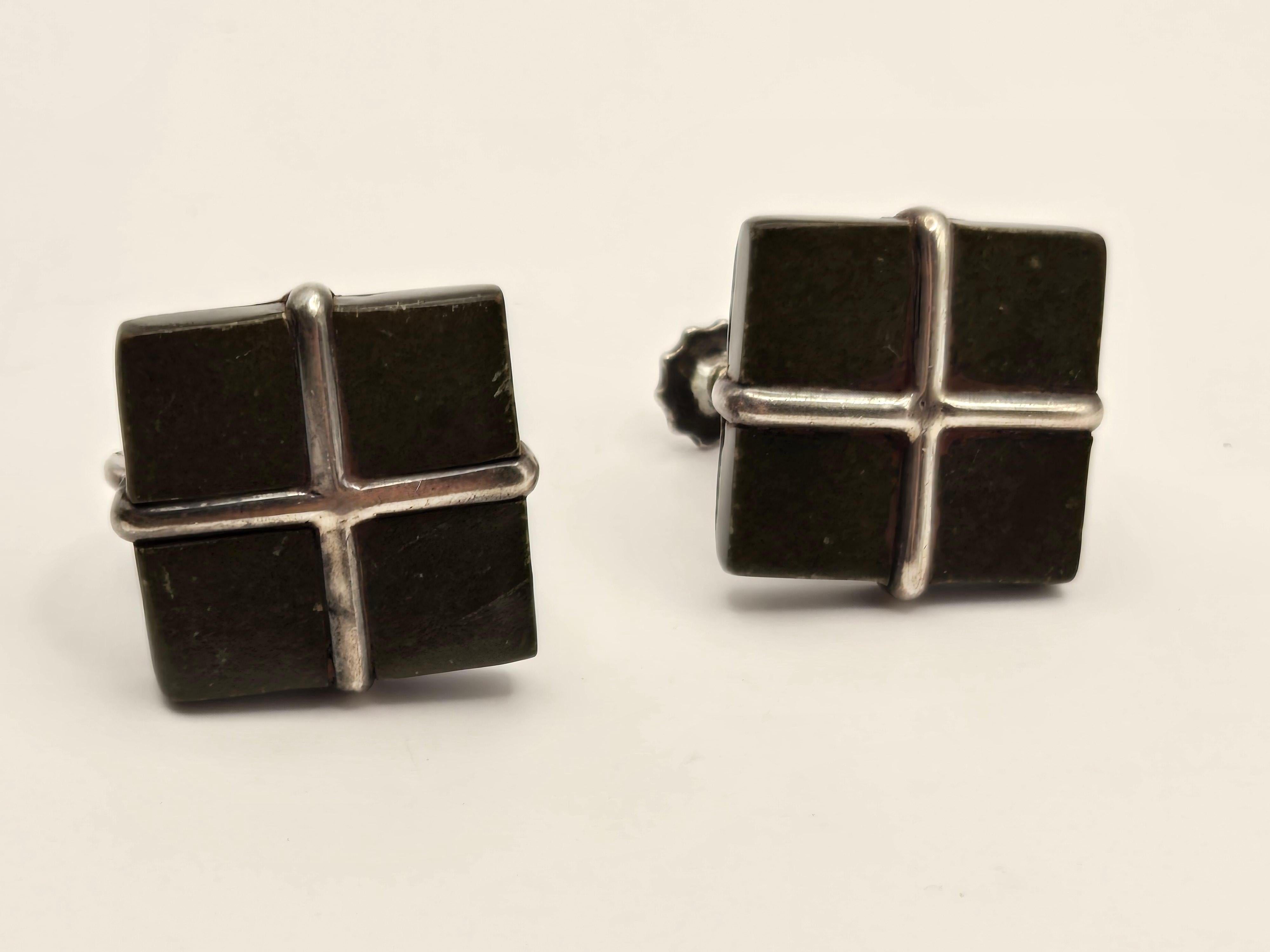 A pair of simple, elegant Los Castillo earrings. The metal is sterling silver and the gemstone appears to be Aztec jade but I am unable to confirm that. These earrings measure .5
