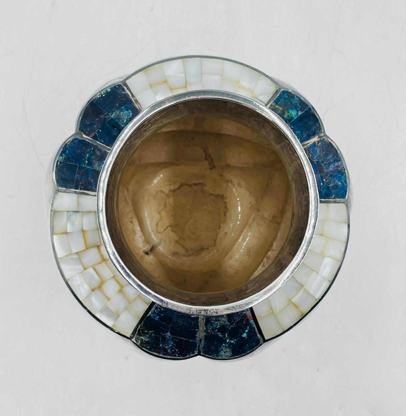 This stunning silver-plated vase designed and manufactured by Los Castillo in the early 1970's.

The piece was handcrafted in Taxco, Mexico, and reflects the studio’s iconic blend of traditional craftsmanship with modern design. The vase features a