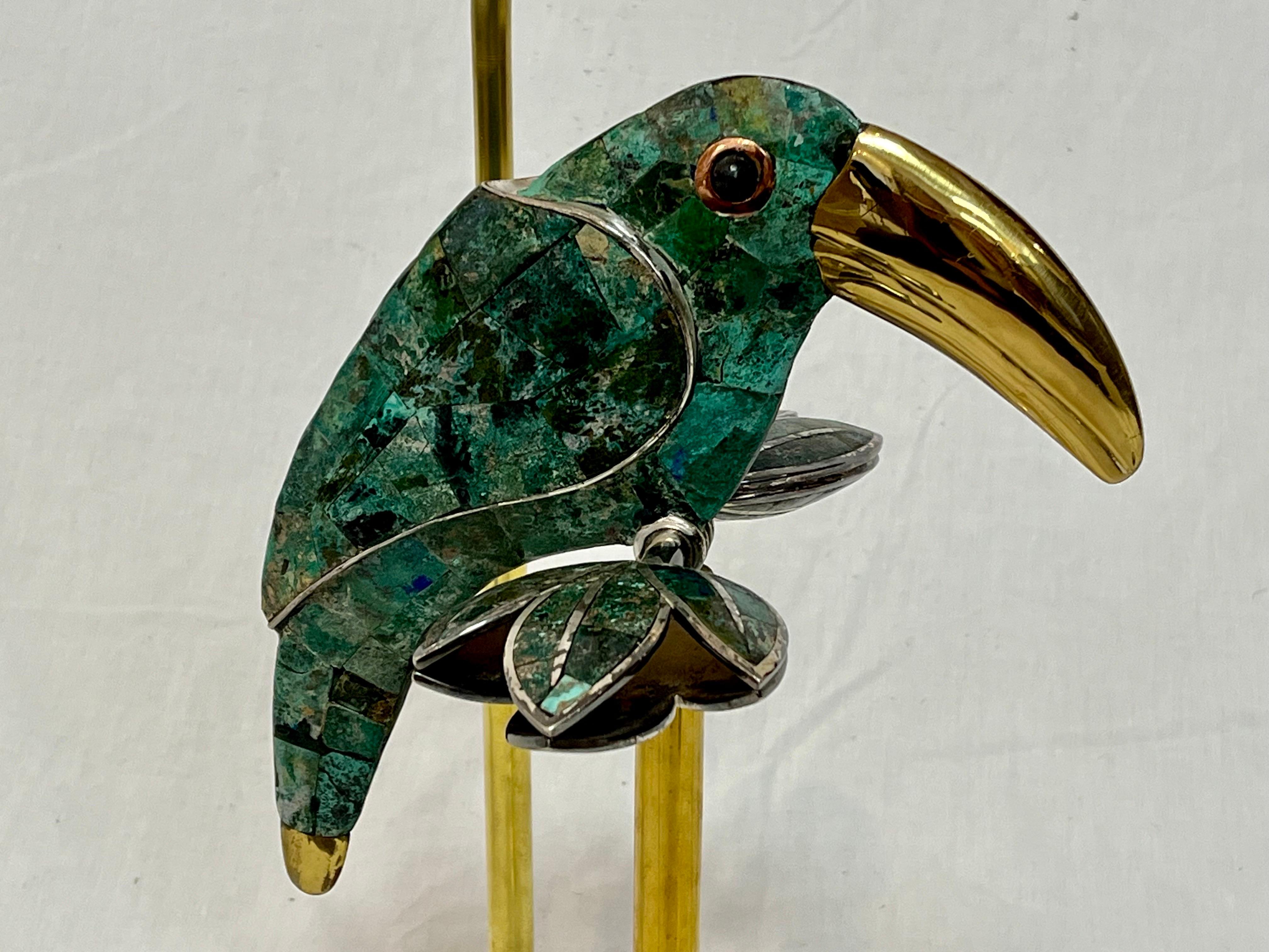 A gorgeous Los Castillo style toucan in semi precious turquoise with silver plate and copper details mounted onto a custom brass and lucite base and newly wired. Yes. I put a bird on it. And by it, I mean a lamp I had custom made for you. This