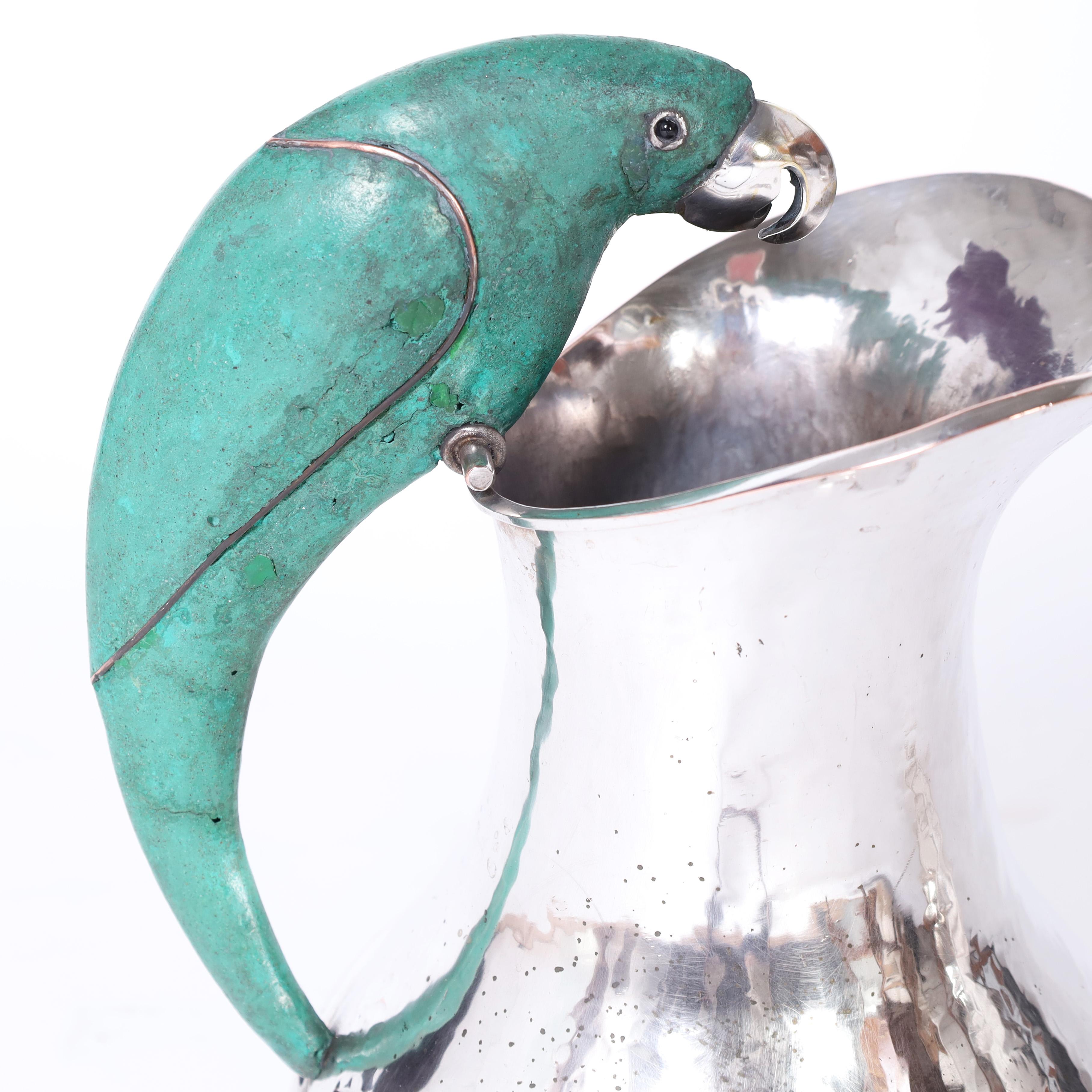 Hammered Los Castillo Style Near Pair of Mid Century Silver Plate Pitchers with Parrots For Sale