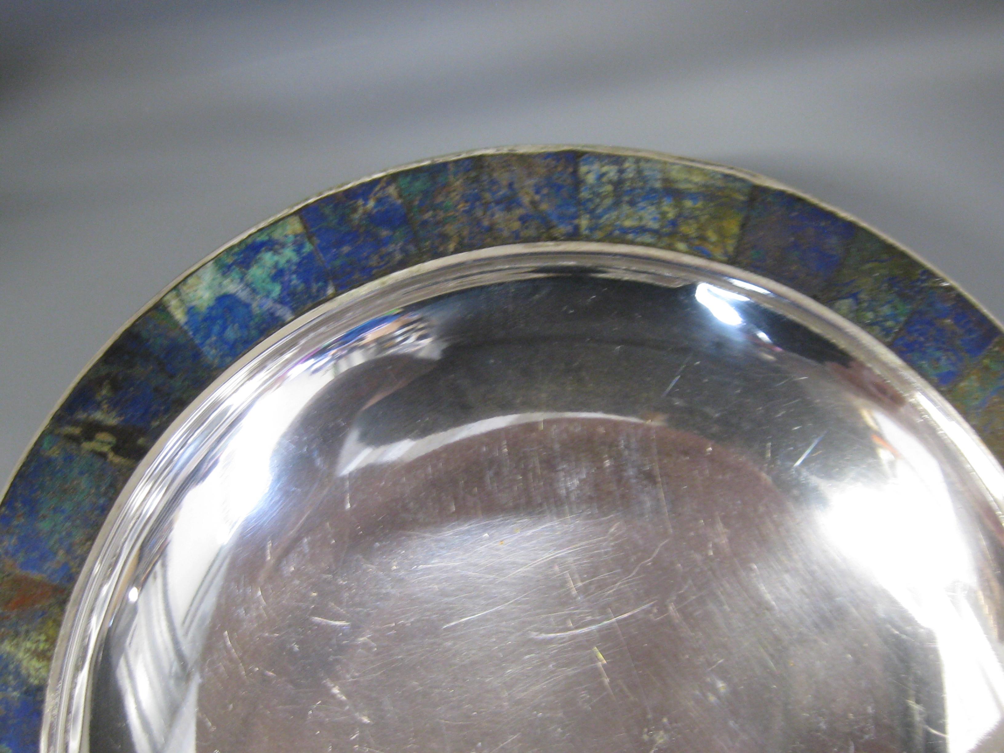 Wonderful silverplated Los Castillos bowl with an inlayed malachite and turquoise edge. This wonderful bowl dates from the 1950's and was made in Taxco, Mexico. Signed on the bottom. Wonderful design and form. In nice condition for its age. No chips