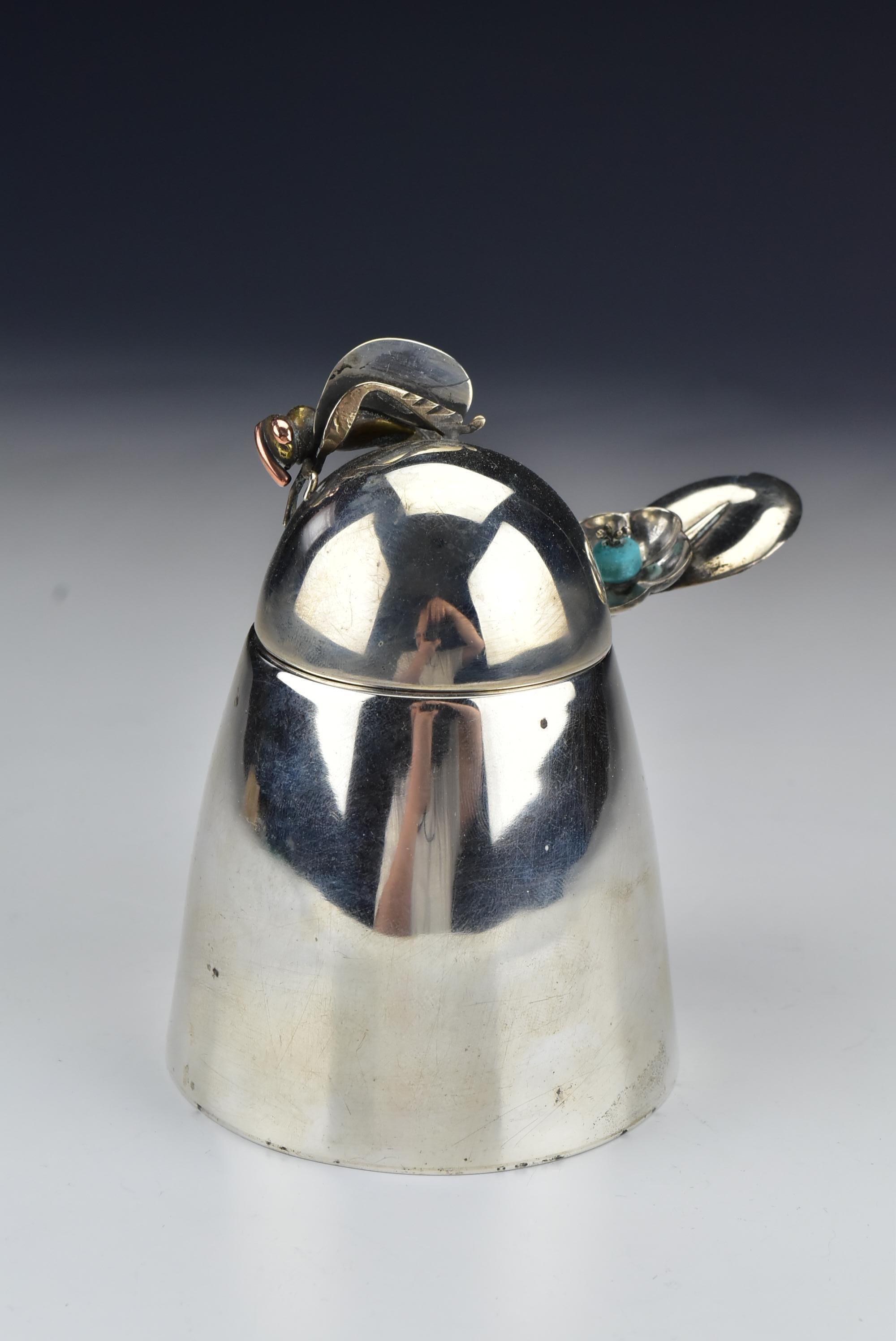 Description: Beehive form Sterling silver honey pot with a figural mixed metals bee (silver, copper & brass) and ladle with a figural flower head and turquoise, marked Sterling, Los Castillo, Taxco, Hecho Amano Mexico, and has makers marks, as
