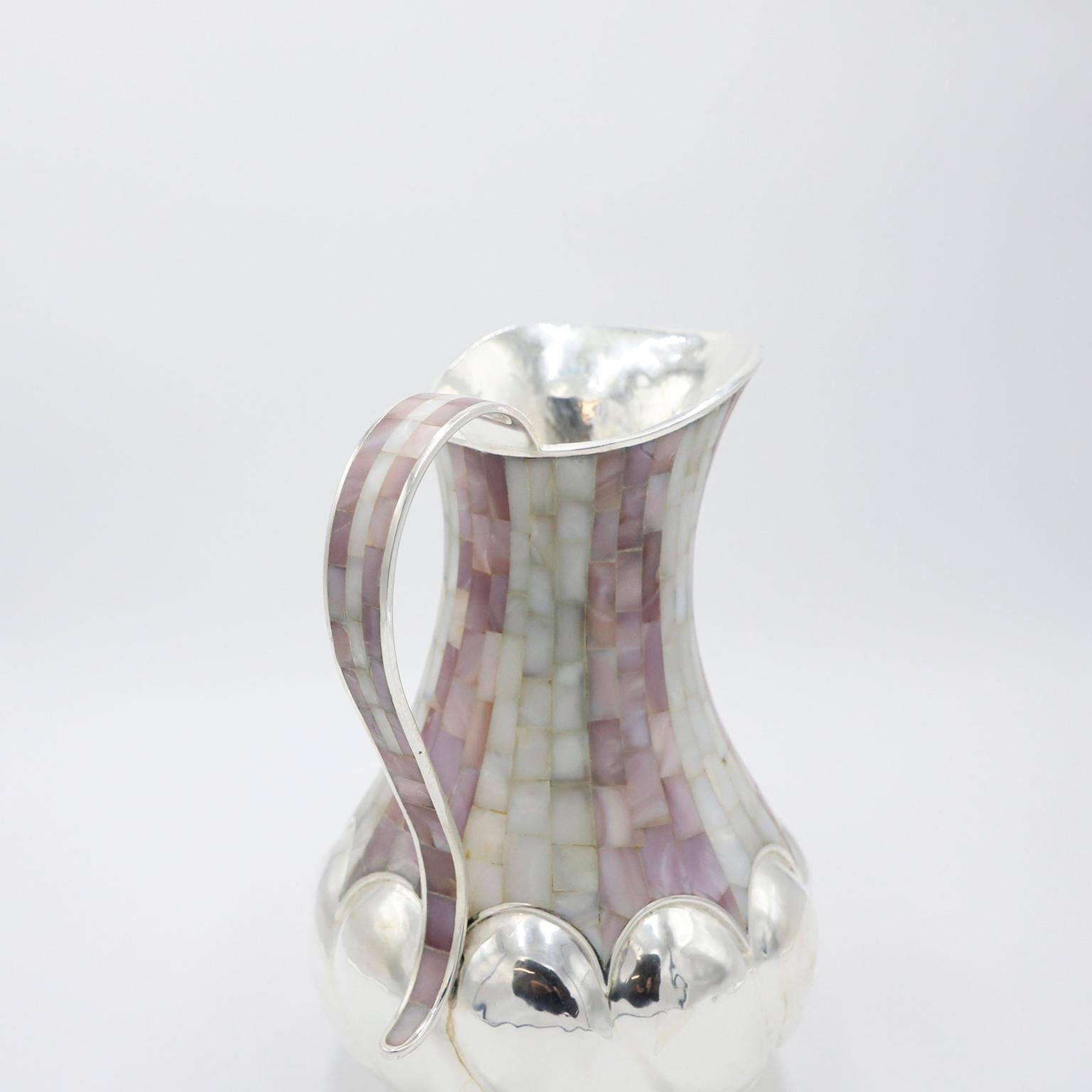 Circa 1960 . We offer this Silver Plate Pitcher designed by Los Castillo in Taxco México. The Pitcher is made of steel that has been restored and silver plated again. The mother of pearl inlays across the pitcher are carefully cut and placed in such