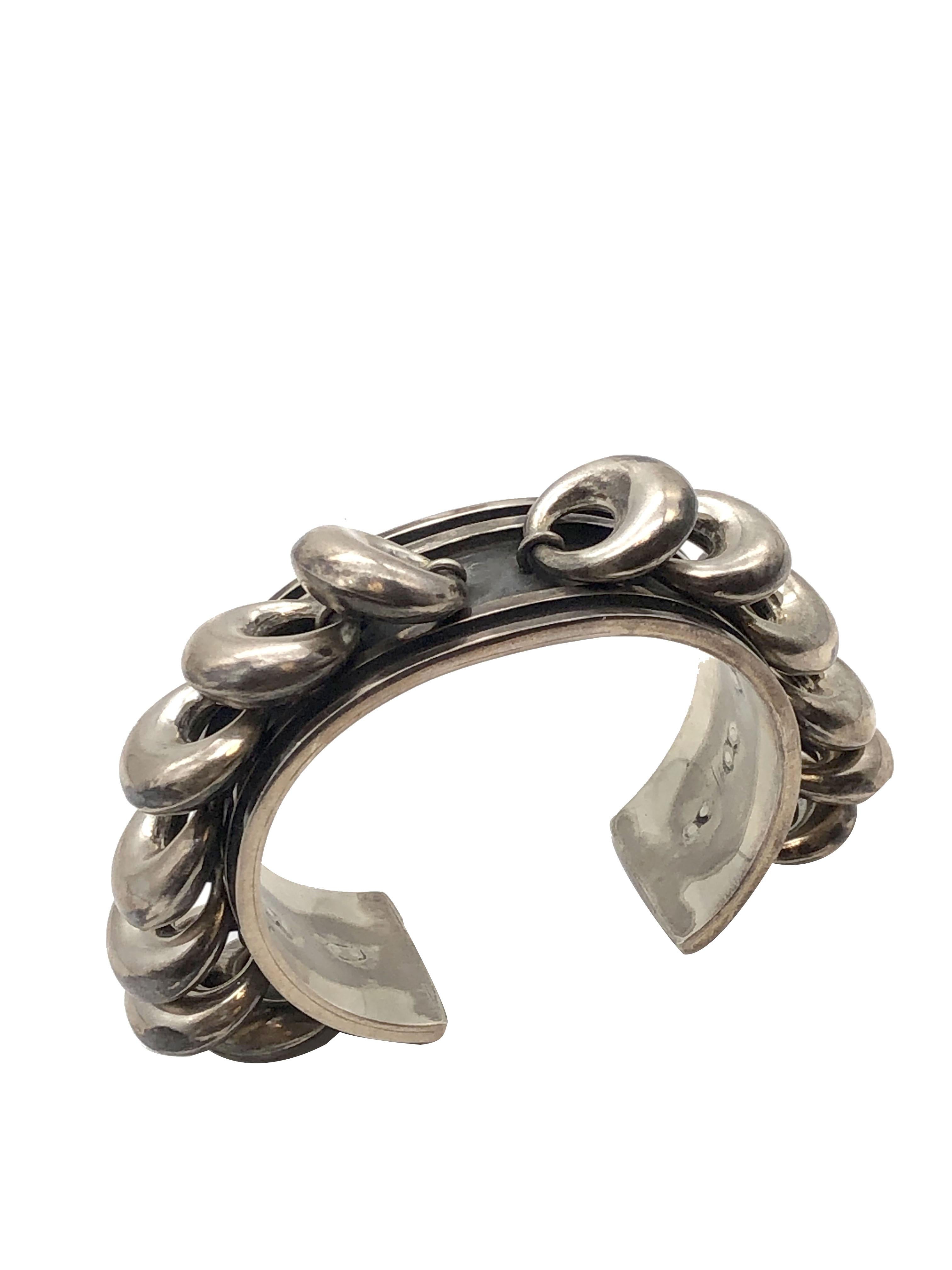 Circa 1960 Los Castillo unique Modernist Sterling Silver Cuff Bracelet, measuring 7/8 inch wide and having puffy Doughnut shape pieces that are each attached from a jump ring giving them movement with the turn of the wrist. Nice solid construction