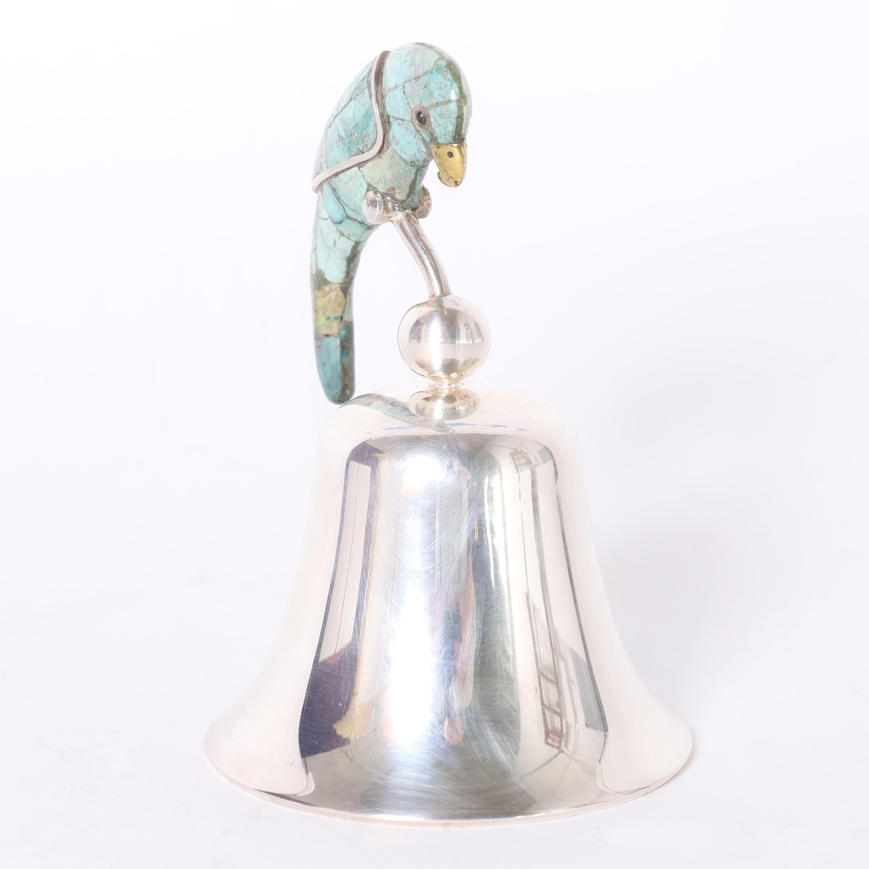 Ringing mid century handcrafted silver plate on copper dinner bell with a stone clad bird or parrot as a handle. Stamped Los Castillo on the inside. 