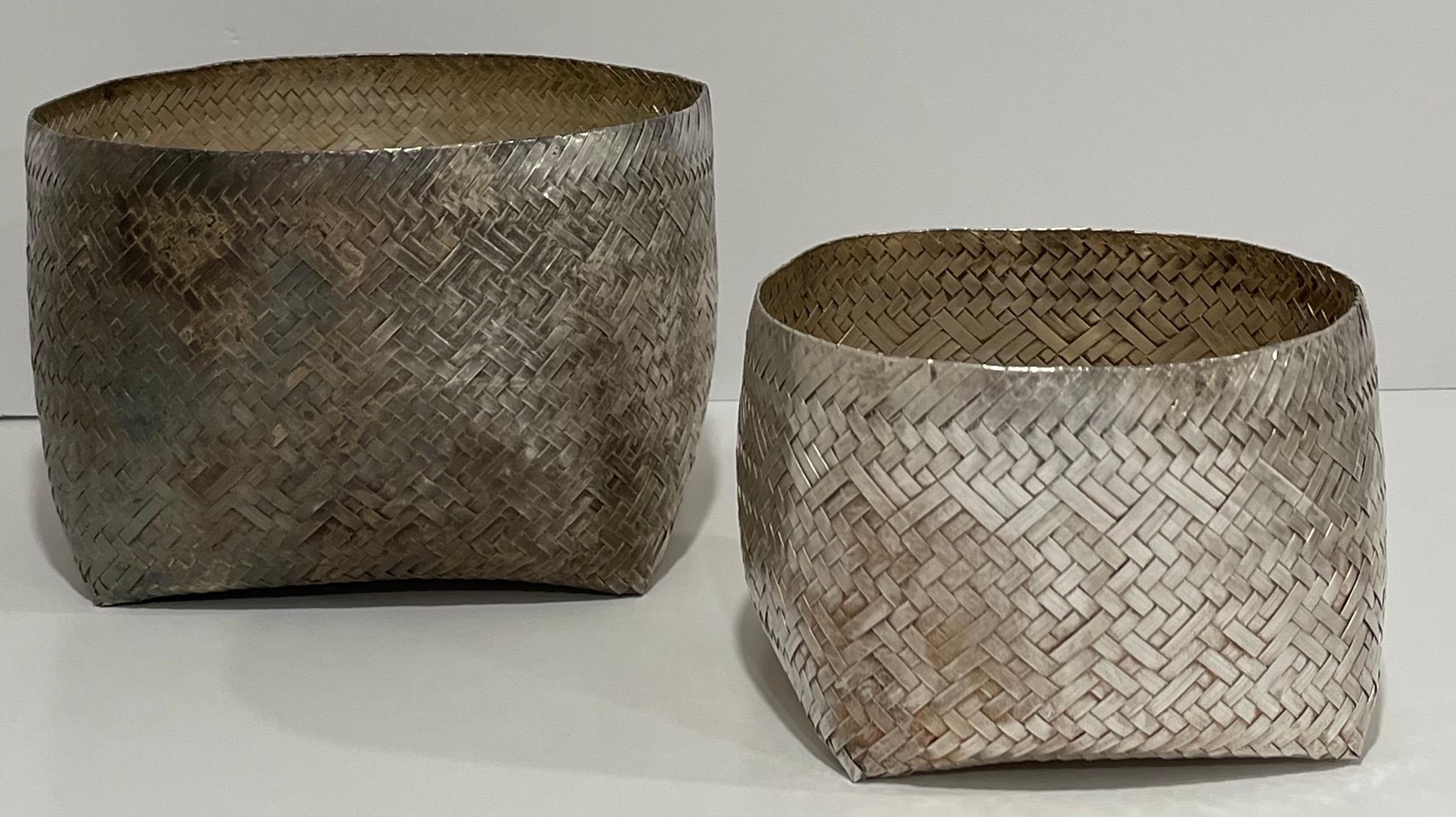 Pair of Los Castillo woven silver baskets. Baskets retain unpolished patina. Larger basket is 7” wide x 4.75” tall. Smaller basket is 5”wide x 3.5” tall. Each basket retains the Los Castillo brand stamp on the underside. 