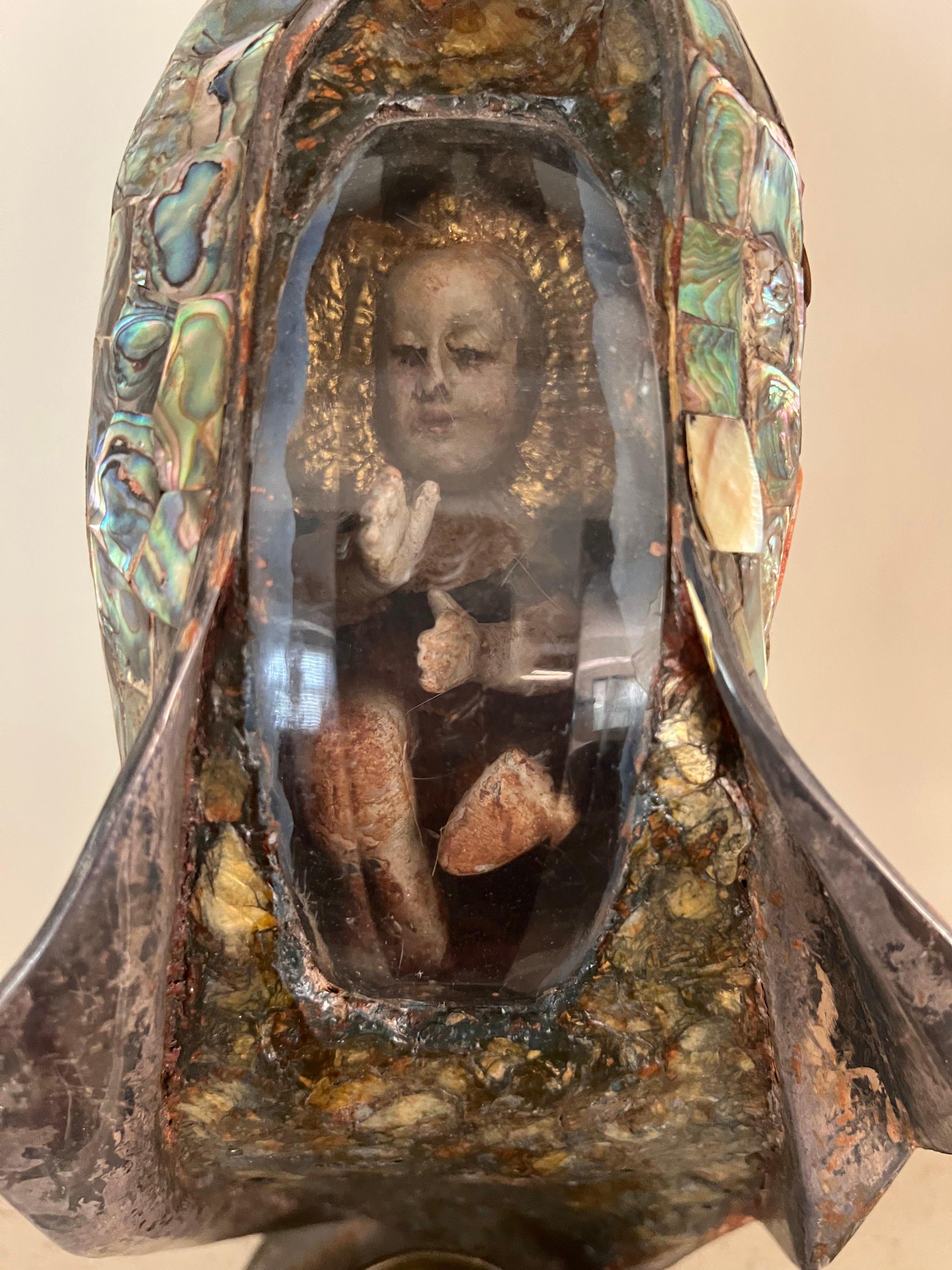- Silver and abalone shell overlay.
- The statue depicts the mother of God with Jesus in her stomach with a cup for holy water.
- Signed by Los Castillos and hallmarked with 400.
- Made in Mexico.
 
The height of the cup is 1 1/2