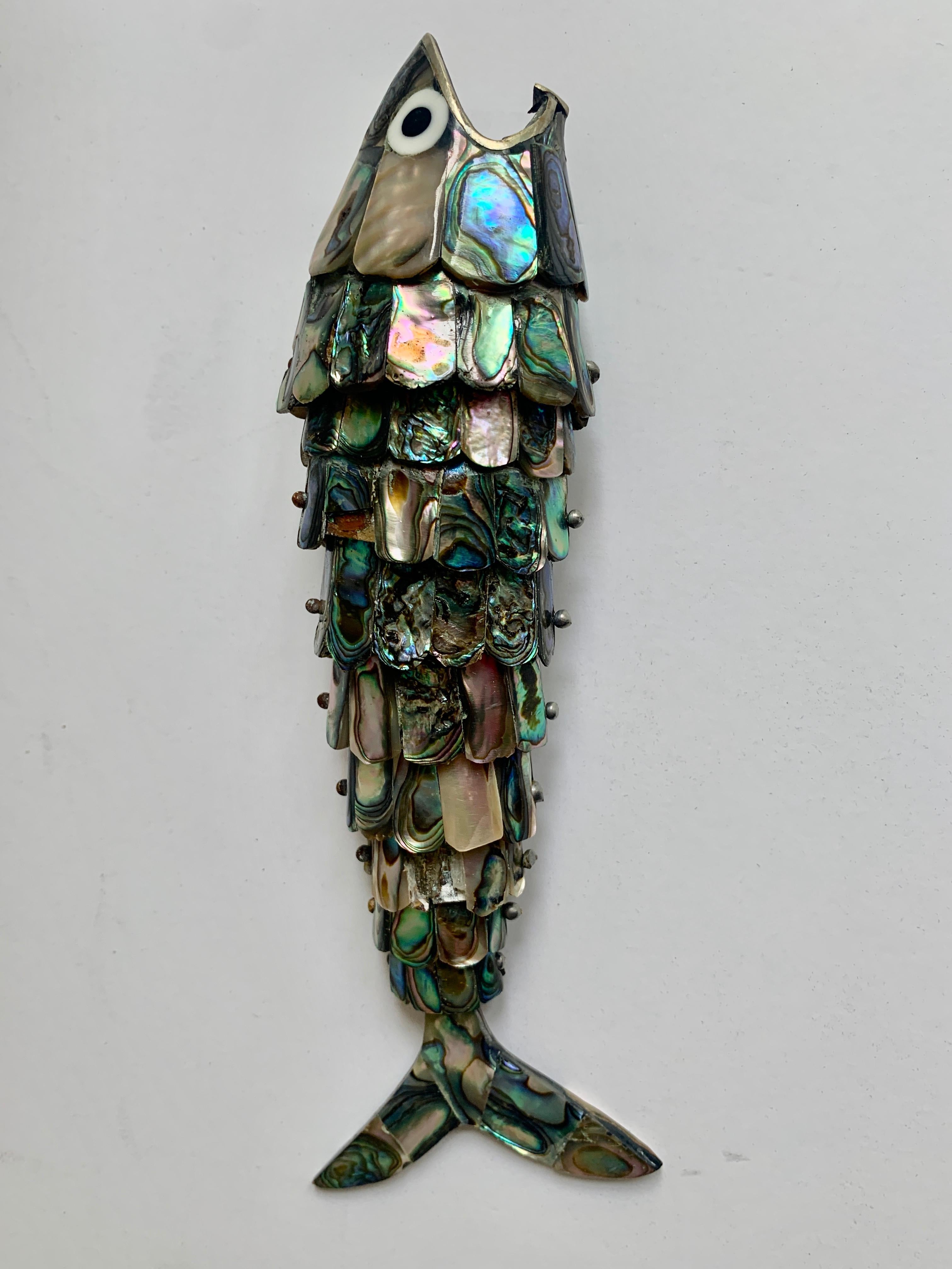 Articulated abalone fish bottle opener - a wonderful midcentury bar favorite. The bottle opener is larger than most we have seen and is a great decorative conversation piece. The unique design allows the fish to stand on it's tail.

      