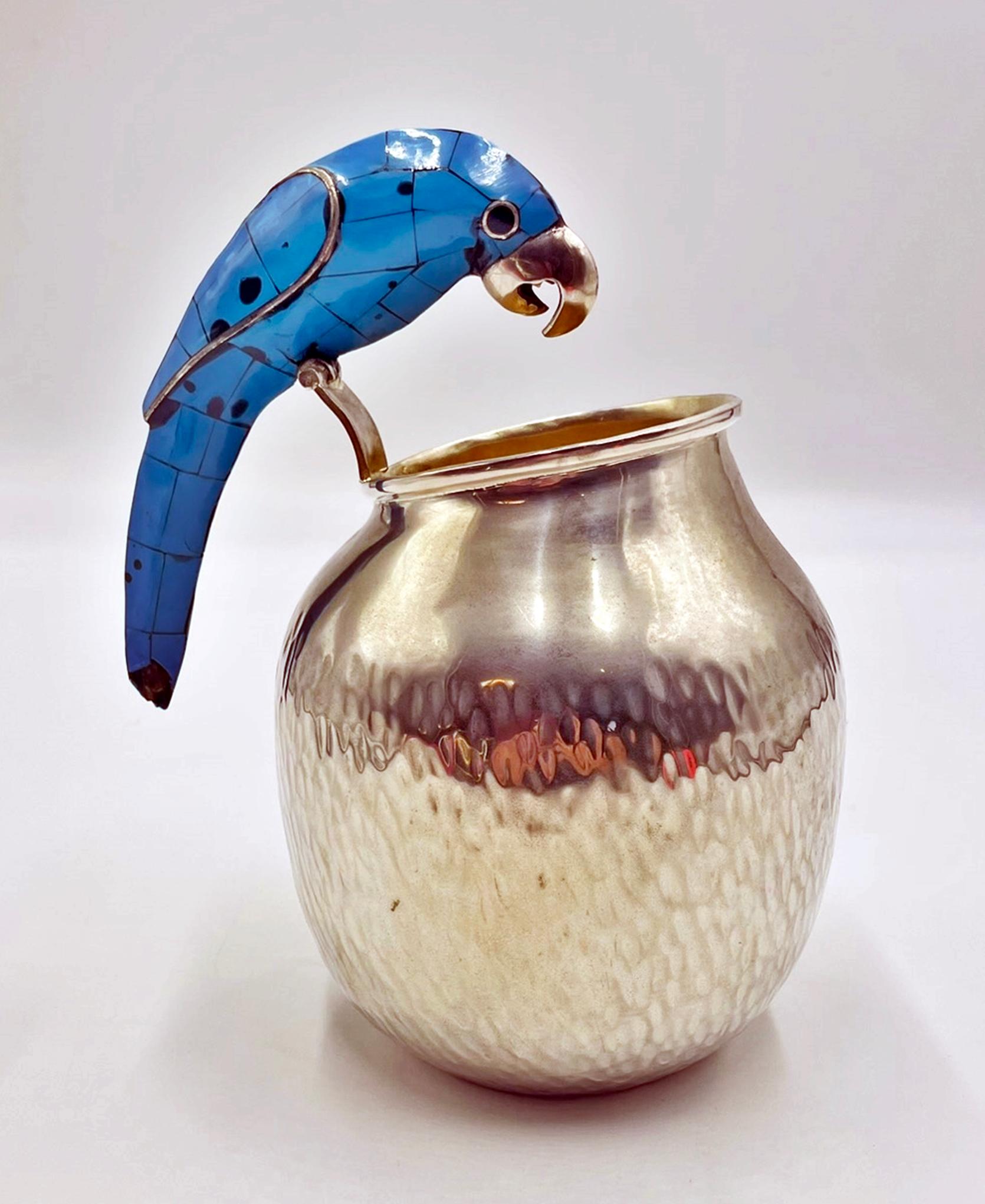 A charming and collectible vintage silver-plated water pitcher designed and handcrafted in Taxco, Mexico by the highly regarded silversmithing workshop Los Fajardo. This sculptural piece showcases the whimsical artistry that made mid-century Taxco