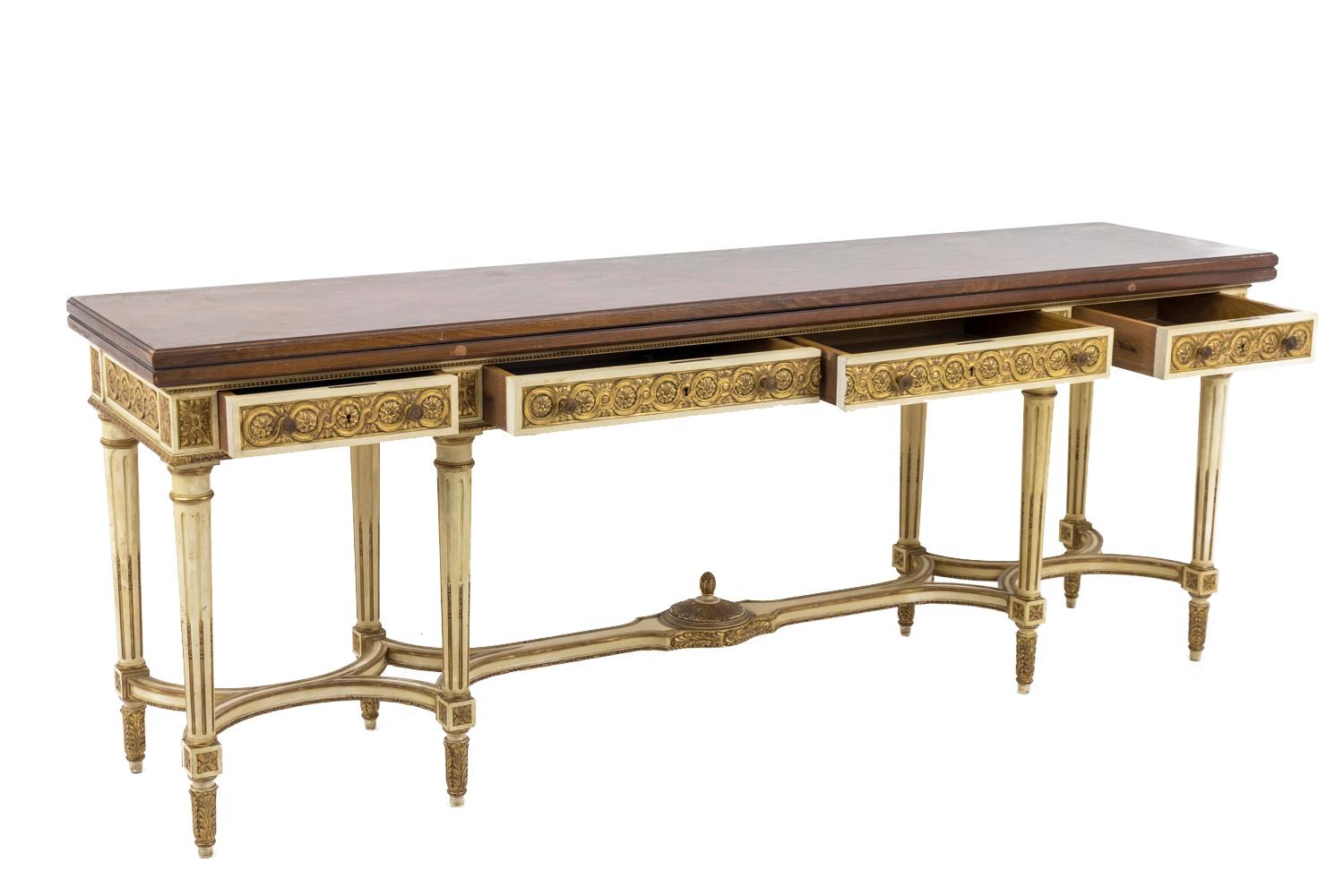 Loscertales Simon, stamped.
Large Louis XVI style console in cream lacquer and giltwood highlights, opening by four drawers in front and standing on four tapered legs with chandelles, finished by acanthus leaves toes. The stretcher is divided in