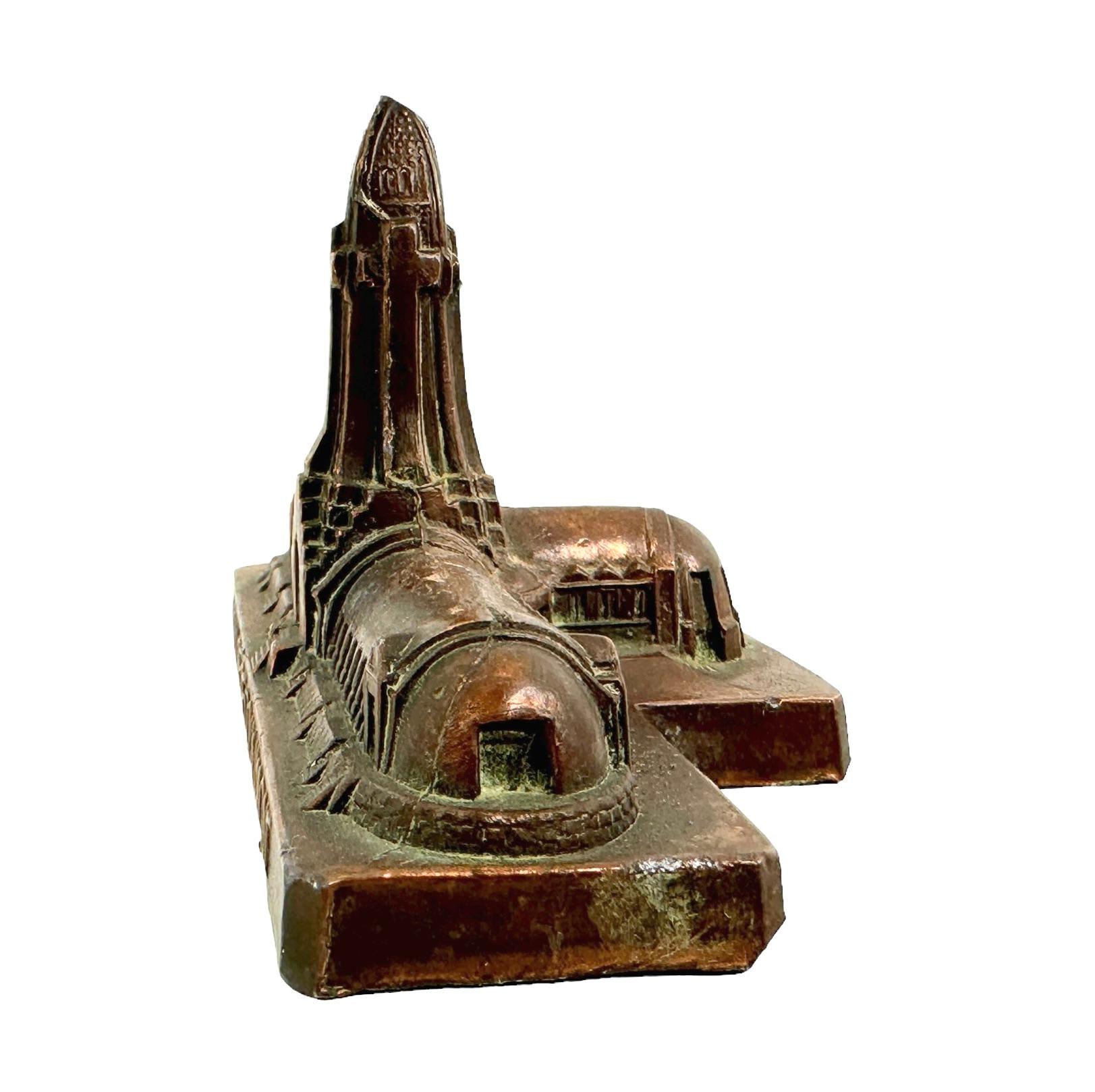 A decorative building sculpture as a souvenir. Some wear with a nice patina, but this is due to age. Made of metal. This item was purchased as a souvenir in Paris, France and was probably made in the 1950s or earlier. Found at an estate sale in