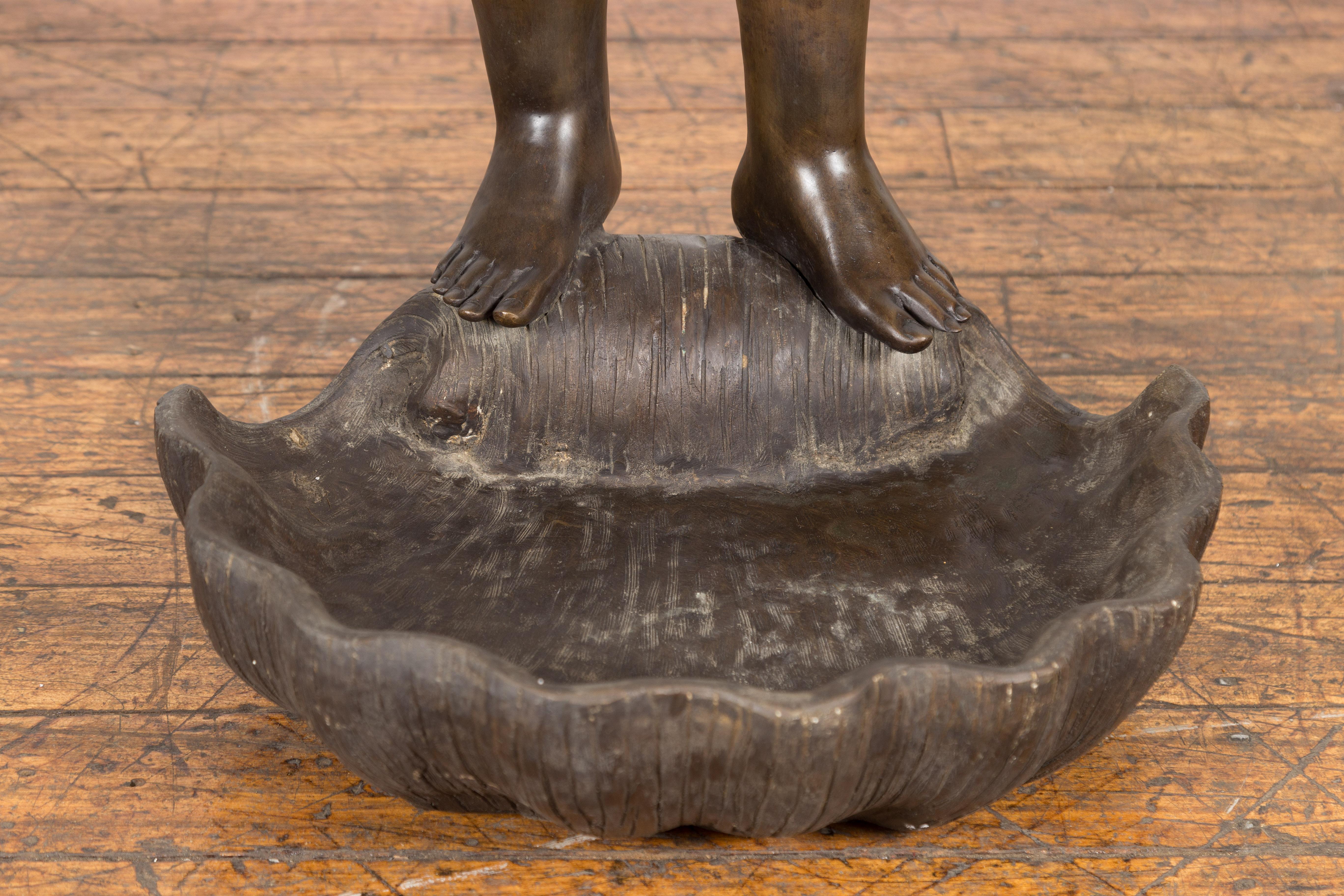 Gréco-romain Statue en bronze de cire perdue d'un chérubin ailé debout sur un coquillage en patine foncée en vente