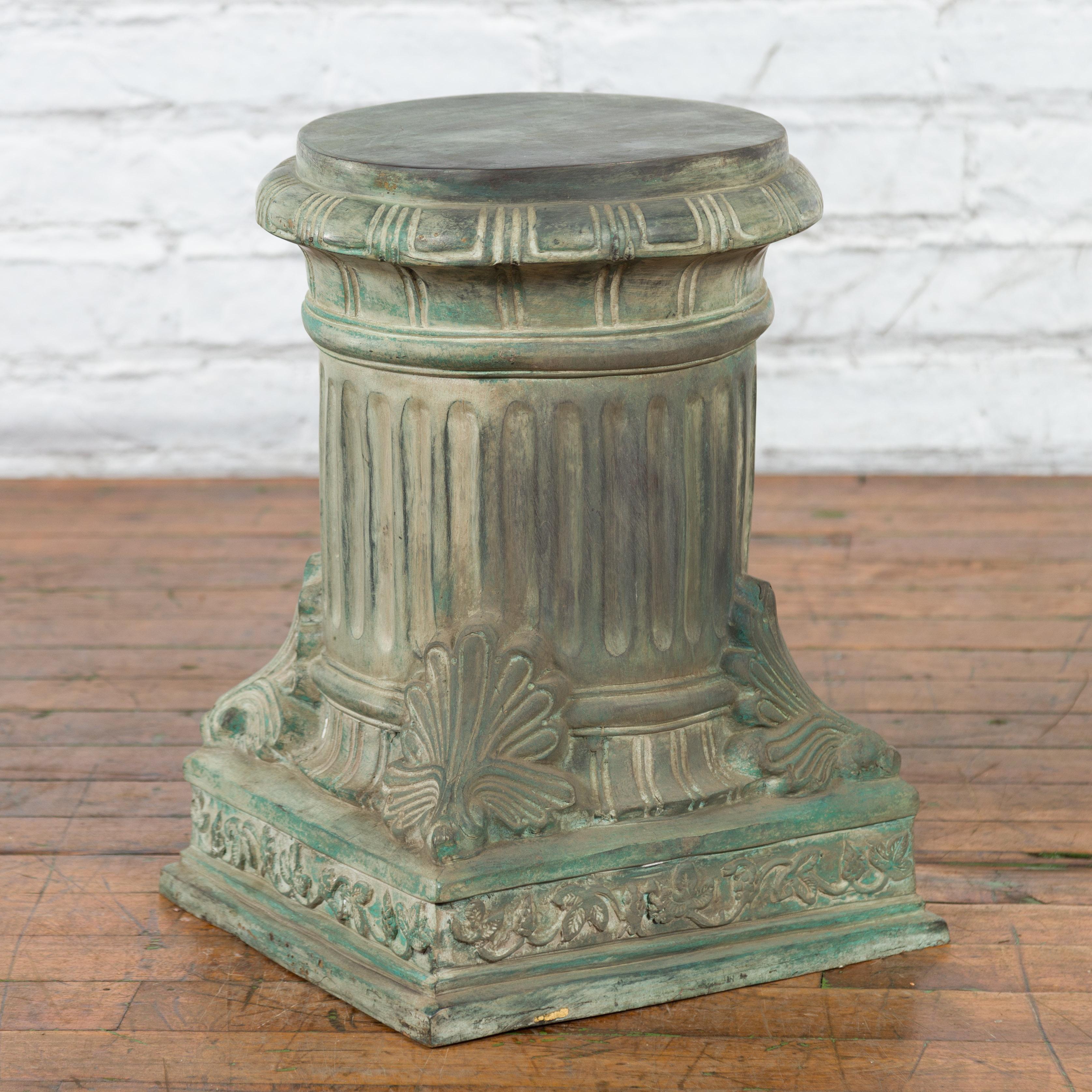 A contemporary lost wax cast bronze pedestal with fluted column and verdigris patina. Created with the traditional technique of the lost-wax (à la cire perdue) which allows for great precision and finesse in the details, this bronze pedestal