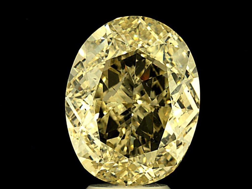 Lot: 8102 GIA Oval 6.01 Cts. Fancy Light Yellow Vs2 Diamond Set in 18k Halo Ring In New Condition For Sale In New York, NY