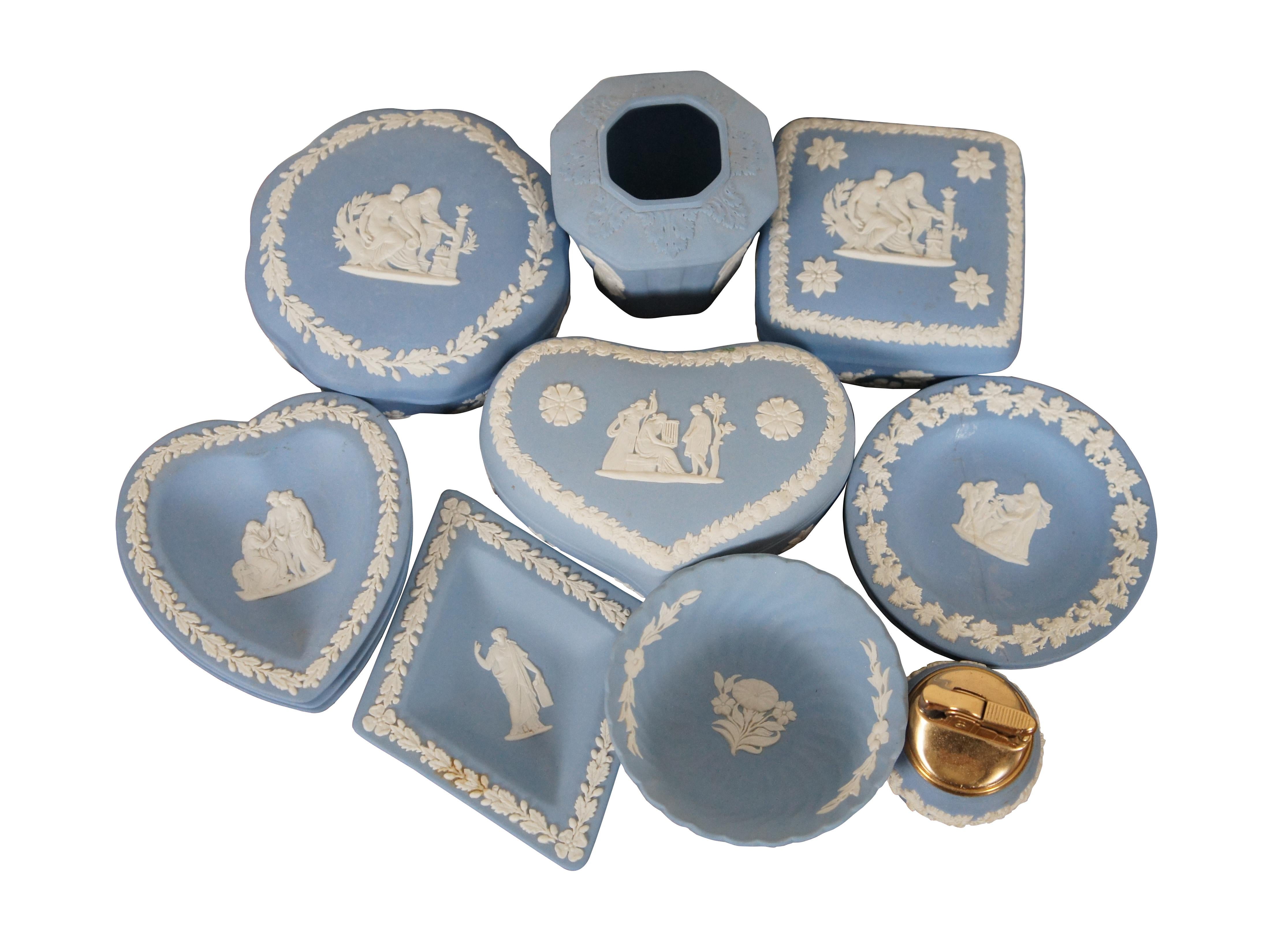 Lot of thirteen pieces of Wedgwood cream on lavender (light blue) Jasperware. Set includes a round scalloped trinket box, square trinket box, heart trinket box, table lighter, bud vase, diamond dish, round swirl bowl, 3 round dishes, and 3 heart