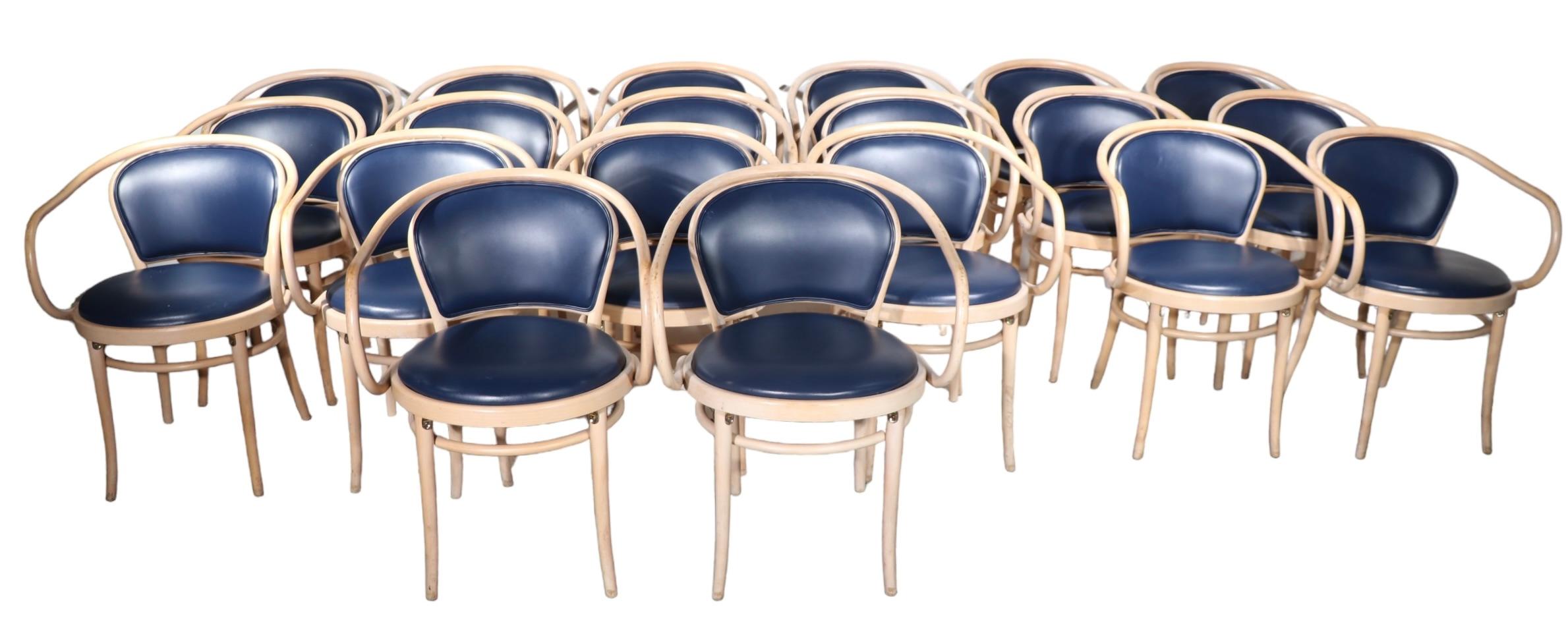 Iconic Vienna Secessionist design bentwood arm chair(s)made by TON. The chairs feature bentwood beech  frames in bleached finish, with dark blue naugahyde seats and backs, the backs of the seat backs are upholstered  in dark blue fabric. This