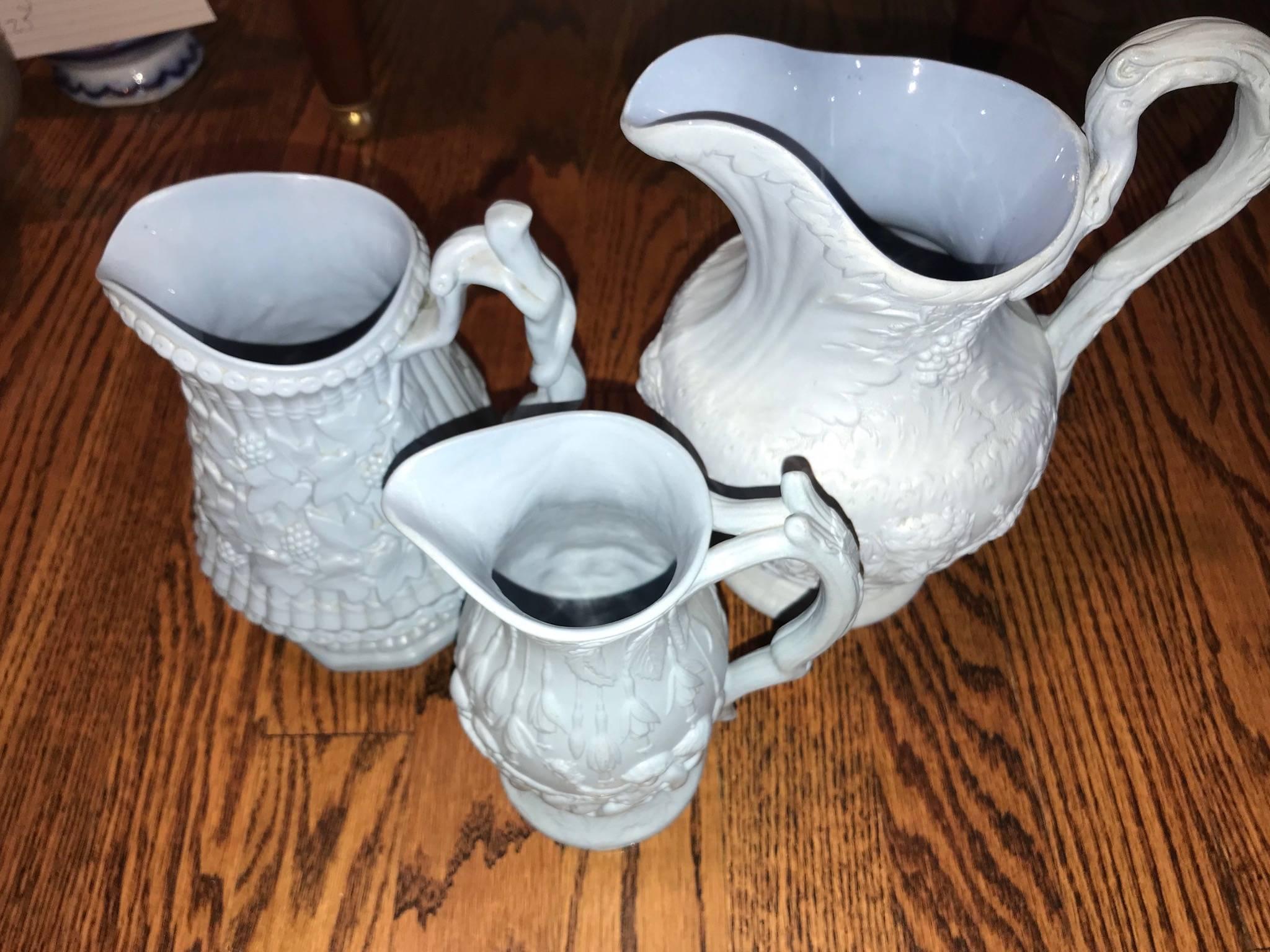 Lot of three blue ceramic relief pitchers/jug by Ridgeway and Abington. Marked on bottom. First: 9