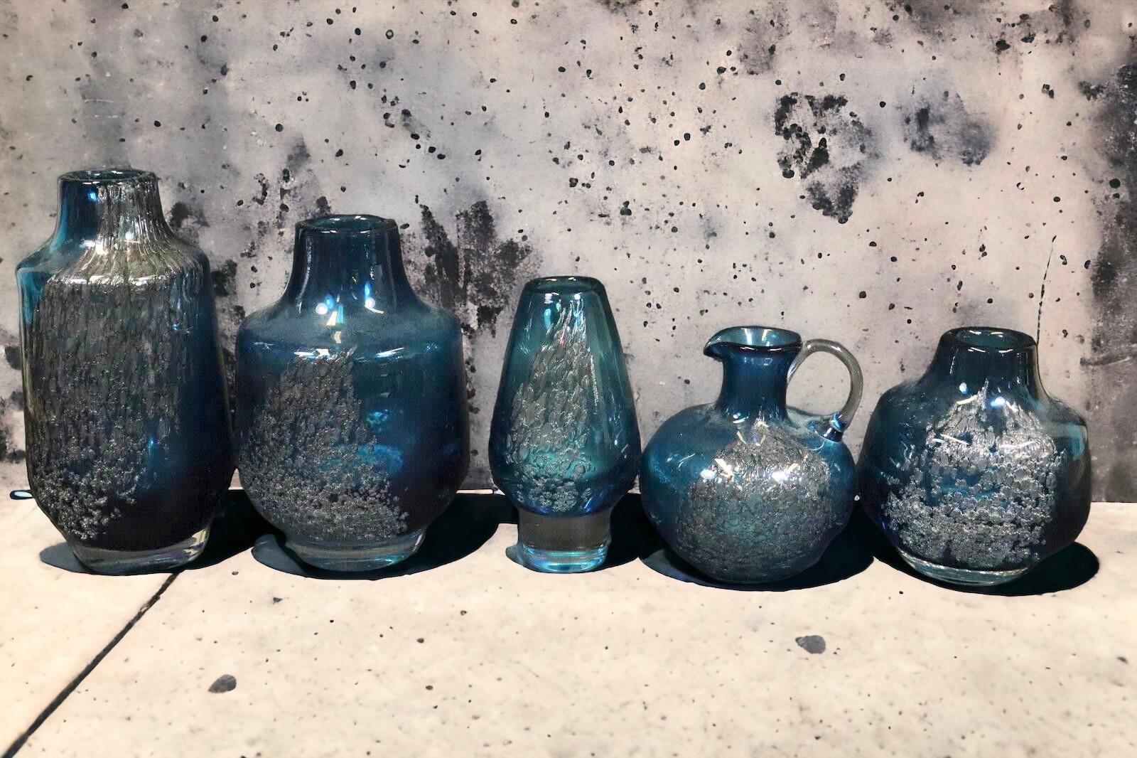 Set of 5 beautiful hand blown german art glass vases. Designed by Heinrich Loffelhardt for Zwiesel Glass in the Bavarian Forest. Clear, blue and silver swirl glass with lots of small bubbles inside. A beautiful piece of art for any room. Marked at a