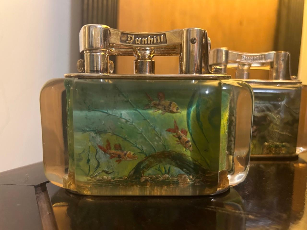 

Lot of 5 Rare 1950s Half-Giant Dunhill Aquarium table lighters (made in England) 

Each of these lighters are very rare and unique as they were hand carved and painted and no one look exactly similar.

Ben Shillingford (1904-2000) commenced to
