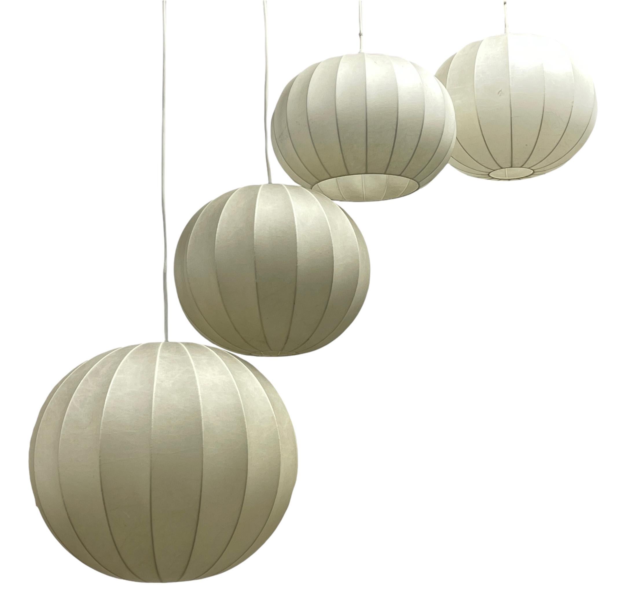 A lot of four cocoon hanging lamps made in Italy in the 1960s. Each has a beautiful round ball design, which is similar to the lamps made by Castiglioni. Biggest Ball is approx. 16
