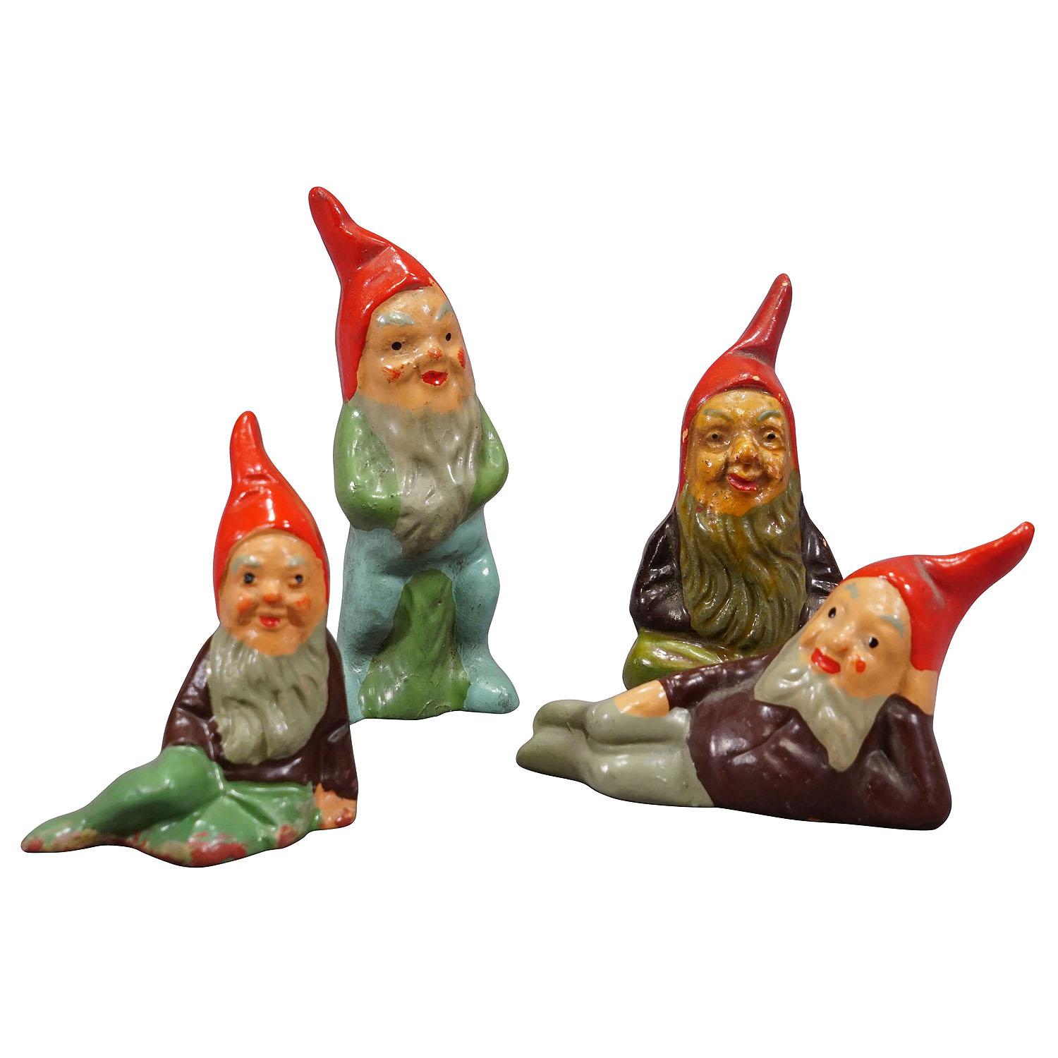 Lot of Four Tiny Terracotta Garden Gnomes, Germany ca. 1950s

A whimsy set of four tiny garden gnomes made in Germany ca. 1950s probably by Heissner. They are made of terracotta and hand-painted with bright colors. Good used vintage condition with