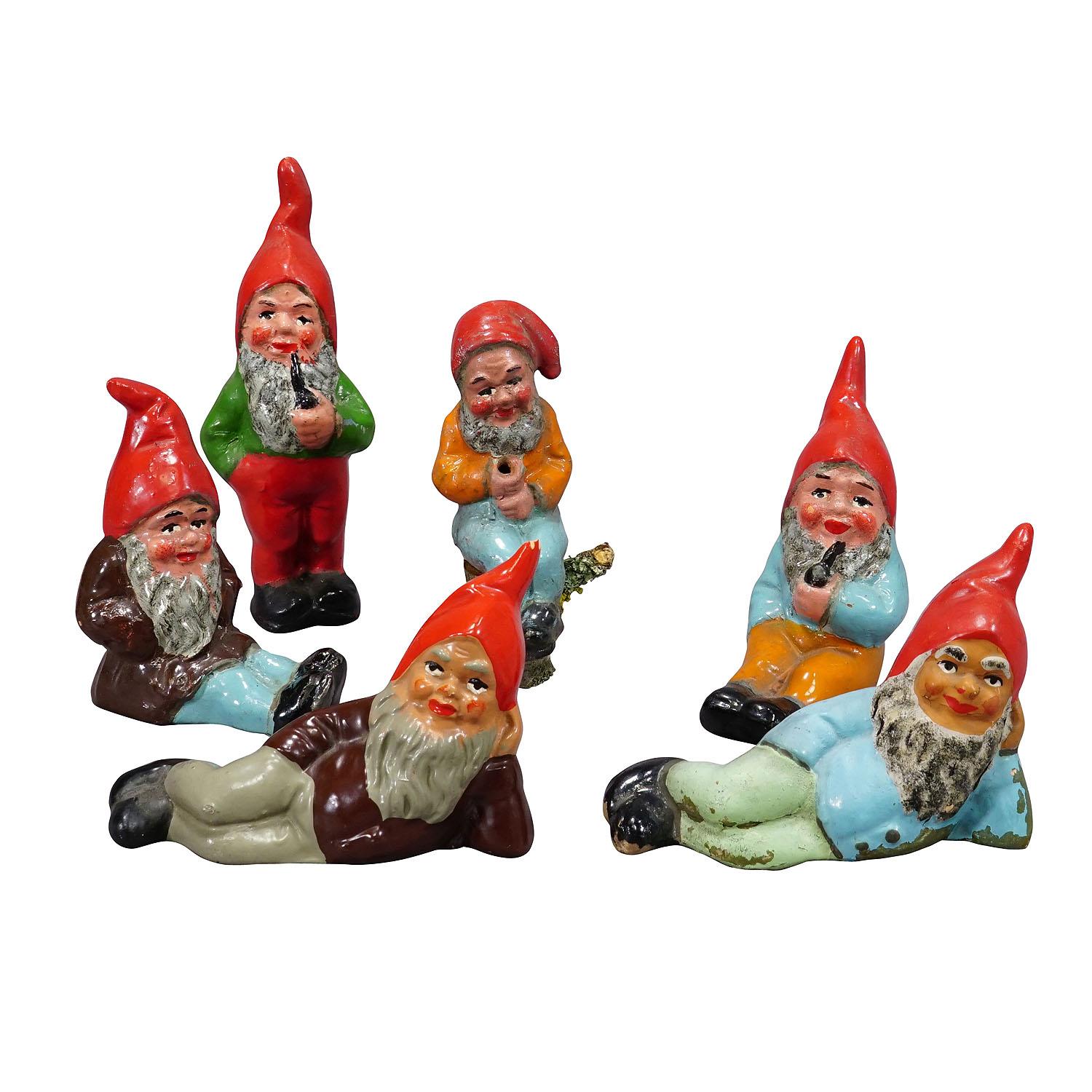 Lot of Six Tiny Terracotta Garden Gnomes, Germany ca. 1950s

A whimsy set of six tiny garden gnomes made in Germany ca. 1950s probably by Heissner. They are made of terracotta and hand-painted with bright colors. Good used vintage condition with