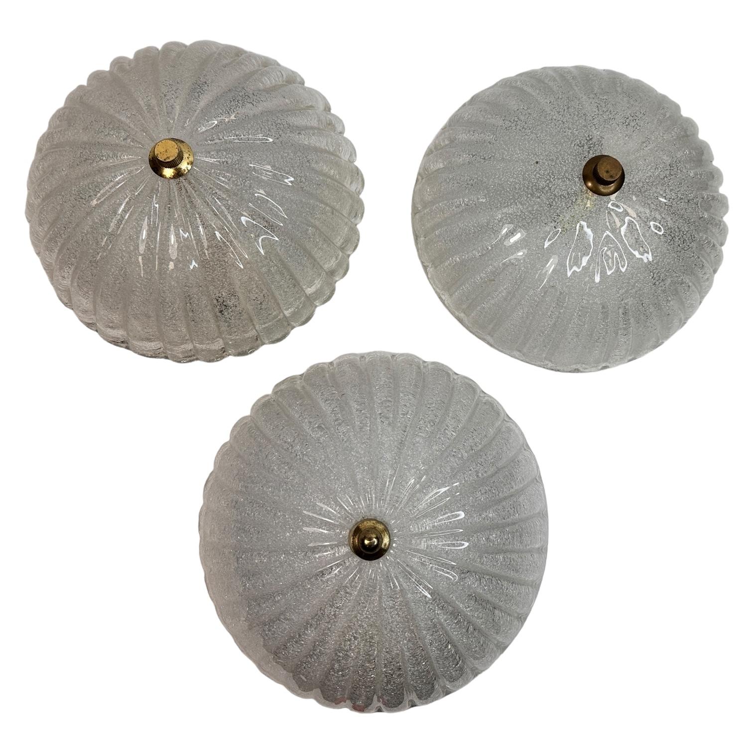 A gorgeous set of three petite glass flush mounts. Made in a starburst pattern design. You can also use them as a wall light. Each light fixture requires one European E27 Edison bulb, up to 60 watts. Found at an Estate sale in Roveretto Italy. A