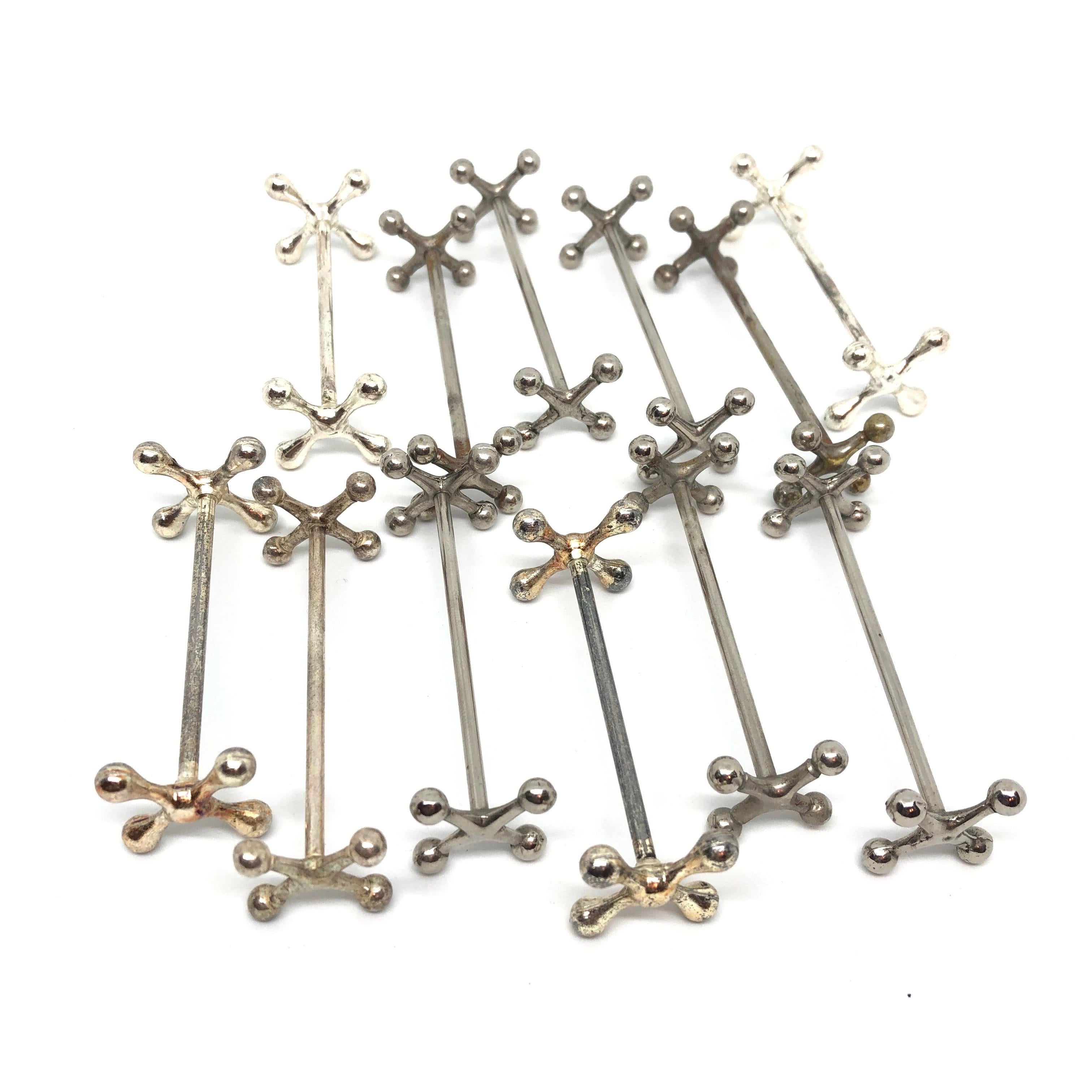 A set of twelve silver plated flatware knife rests, circa 1950s, France. Nice addition to every table or just for your collection. Tarnished and silver plate lost, but this is old-age and gives these pieces a classy statement.
 