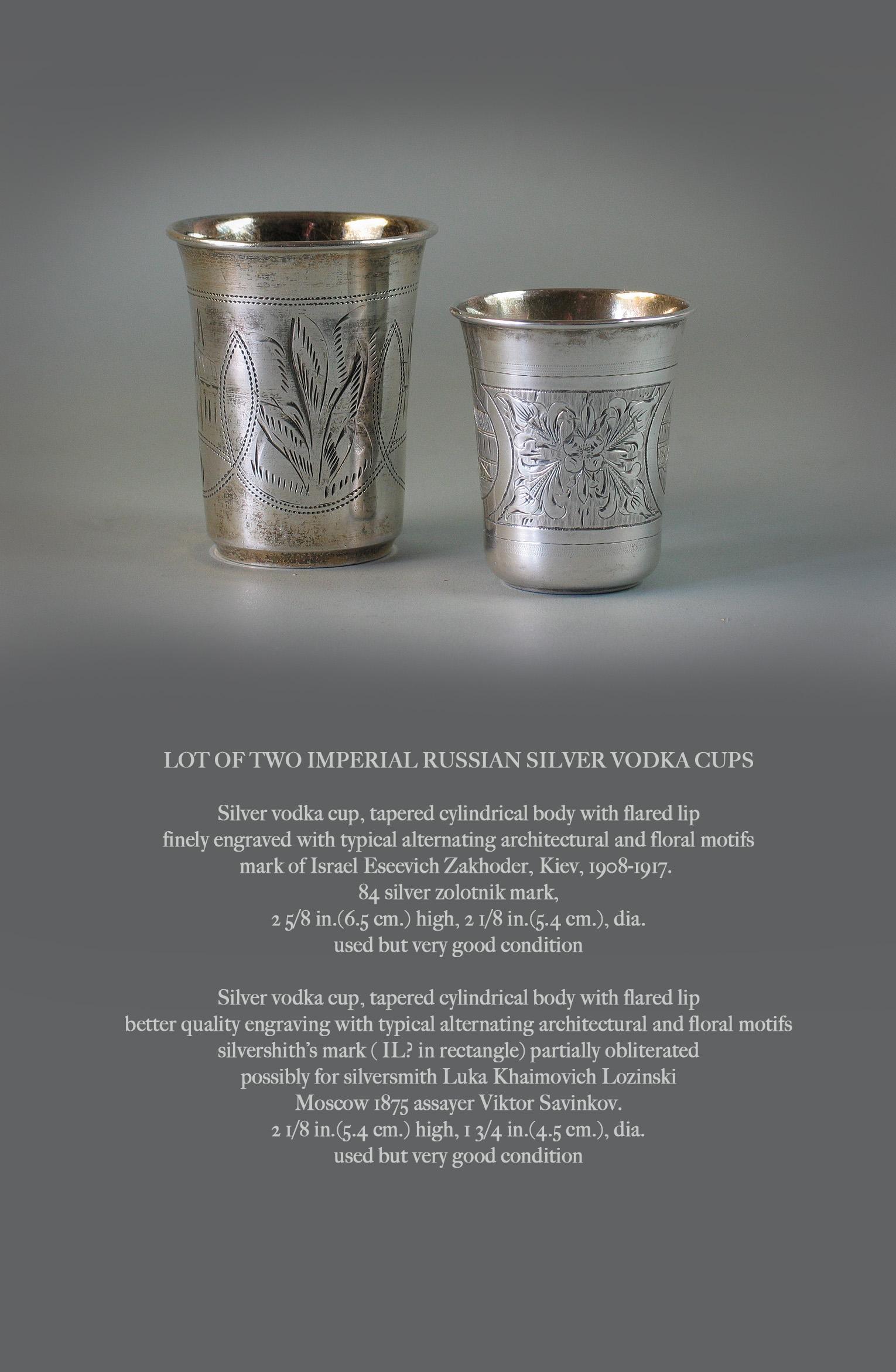 Lot of Two Imperial Russian Silver Vodka Cups

Silver vodka cup, tapered cylindrical body with flared lip
finely engraved with typical alternating architectural and floral motifs
mark of Israel Eseevich Zakhoder, Kiev, 1908-1917. 
84 silver