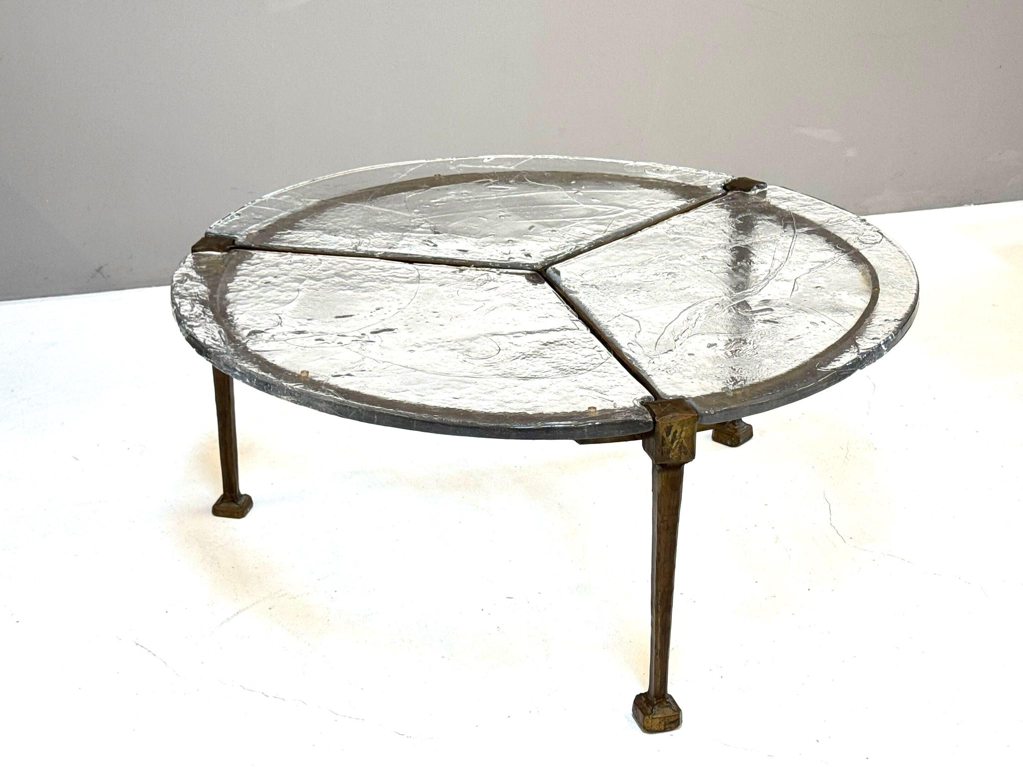 Round coffee table by Lothar Klute for Atelier Lothar Klute.

The table is divided into three glass segments with a forged bronze frame.

A special bronze alloy enabled the artist to forge the bronze. The glass was produced using a specific melting