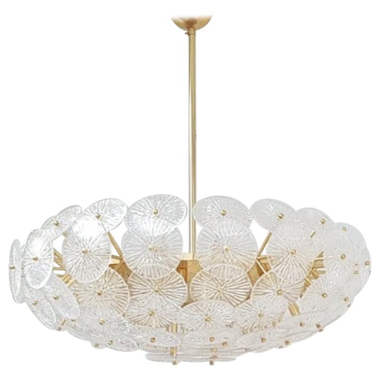 Oversized Italian chandelier with layered textured clear Murano glass discs mounted on solid brass frame in polished lacquered finish, designed by Fabio Bergomi for Fabio Ltd / Made in Italy
16 lights / E12 or E14 type / max 40W each
Measures: