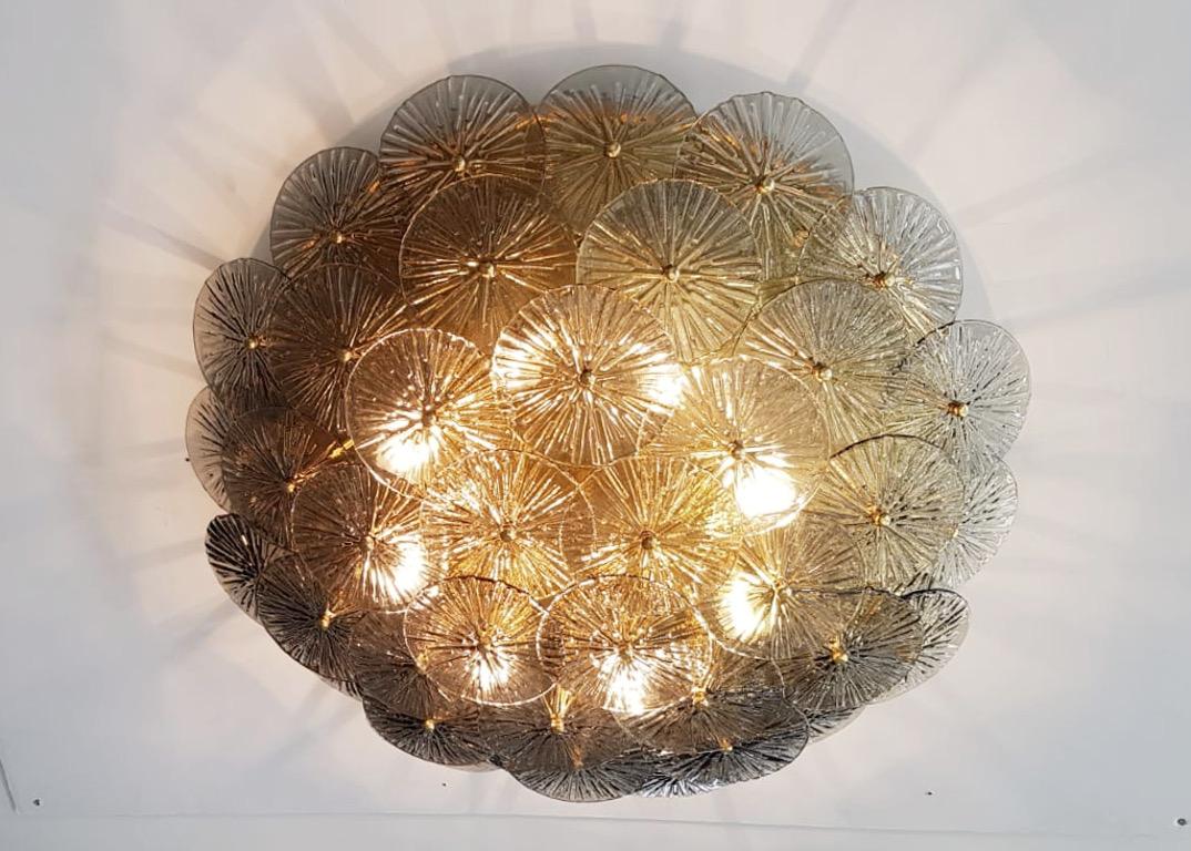 Impressive Italian flush mount with layered textured smoky Murano glass discs mounted on solid brass frame in polished lacquered finish, designed by Fabio Bergomi for Fabio Ltd / Made in Italy
8 lights / E12 or E14 type / max 40W each
Measures: