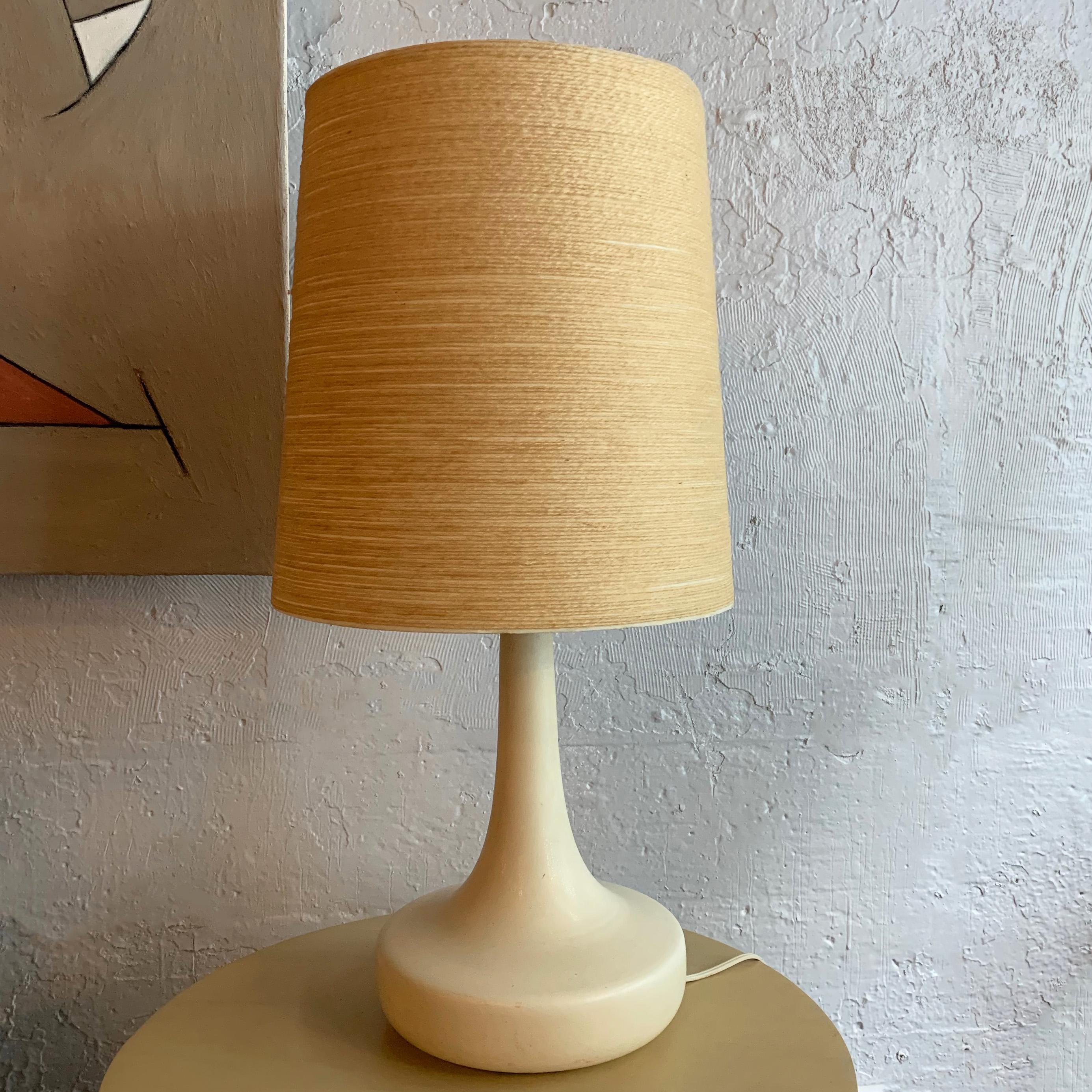 Mid-Century Modern, table lamp by Lotte and Gunnar Bostland features an organically shaped, ecrú ceramic, art pottery base with brass neck and original grasscloth shade.